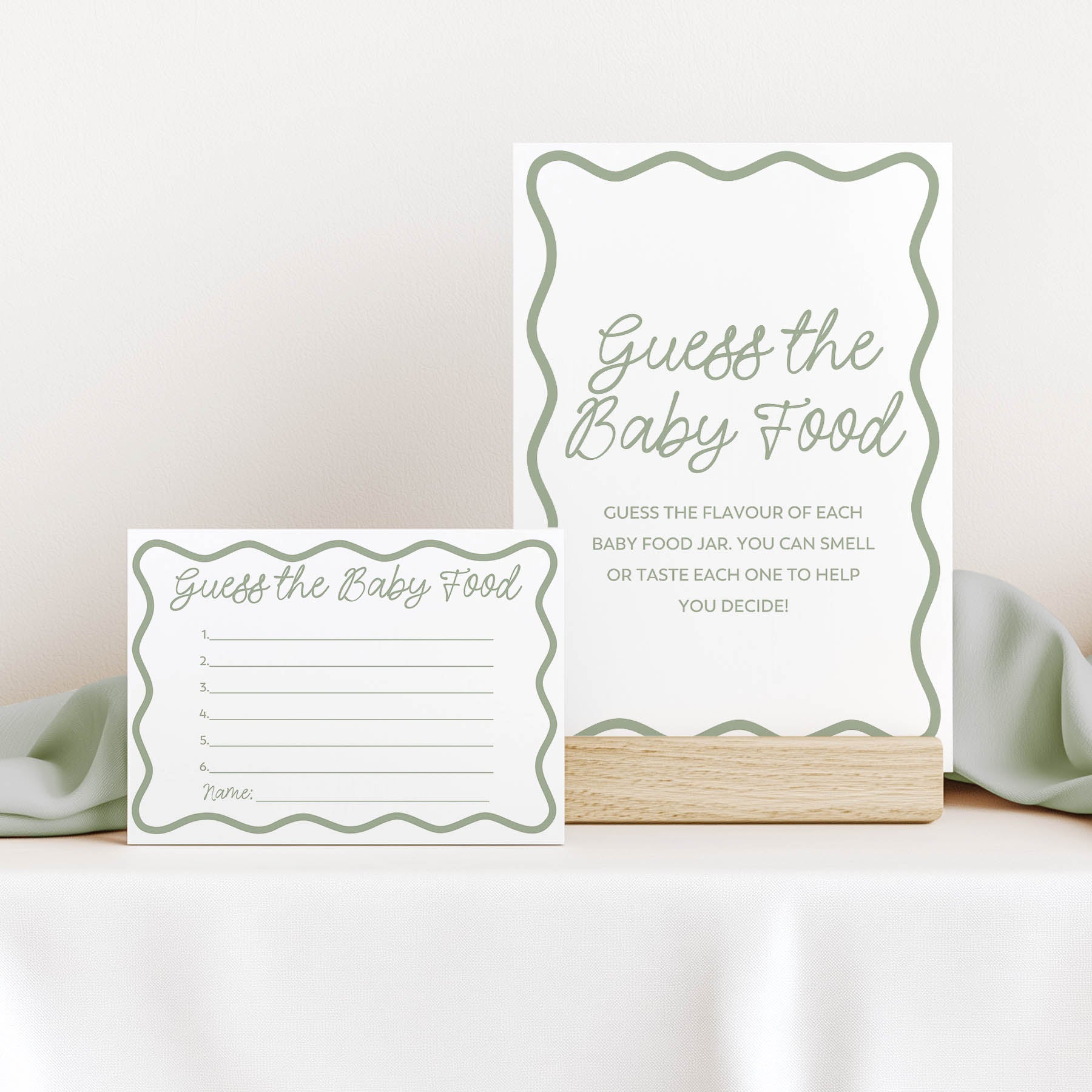 Guess the baby food sign and card in green wavy design for baby shower