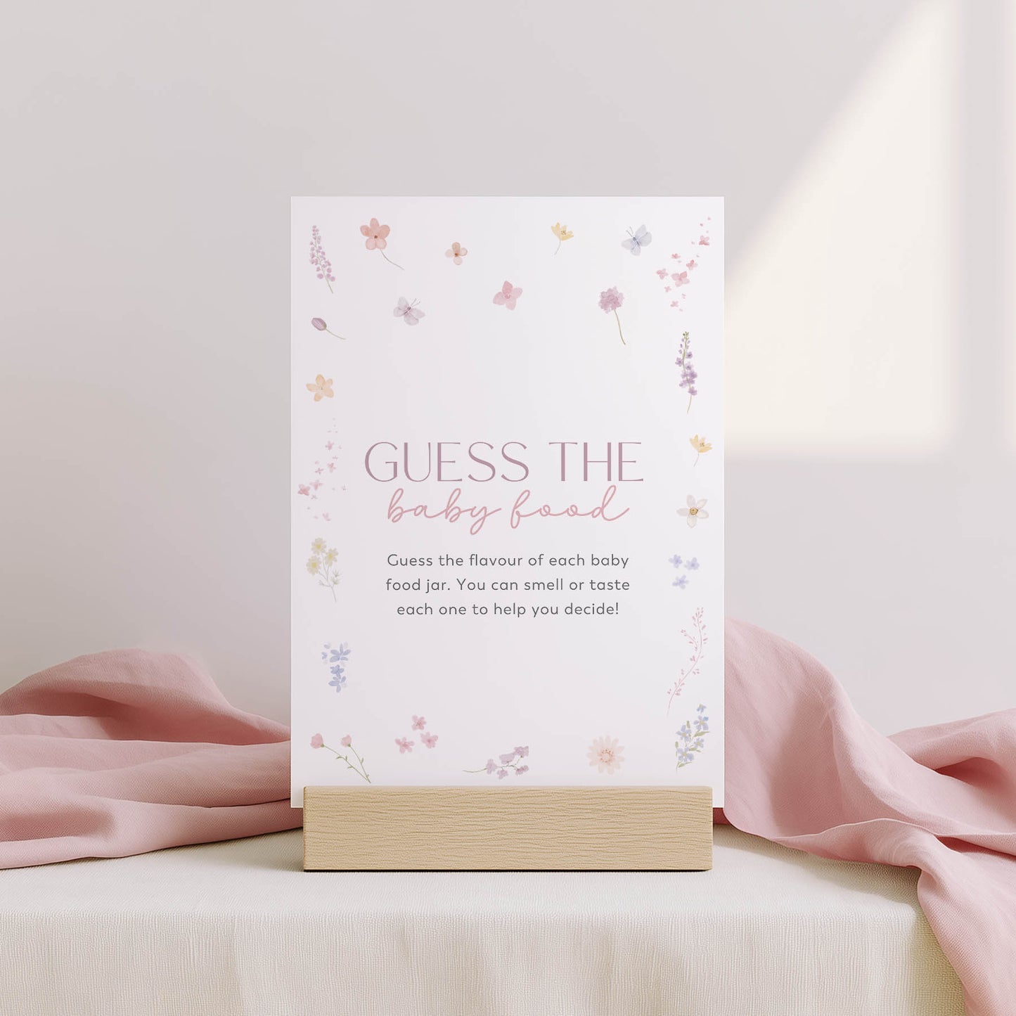 Card with 'Family traditions' text on a stand with floral design, against a light pink background.