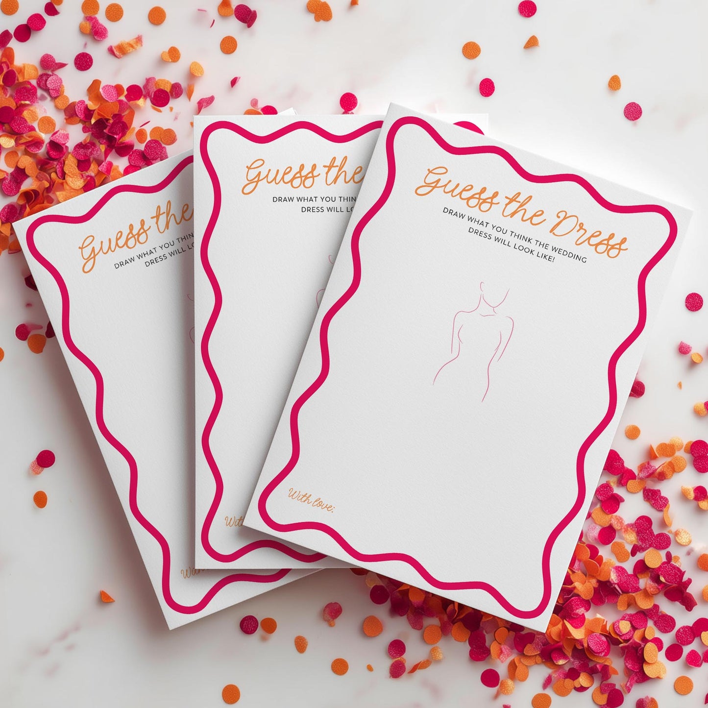Three 'Guess the Dress' cards on a surface with confetti around them.