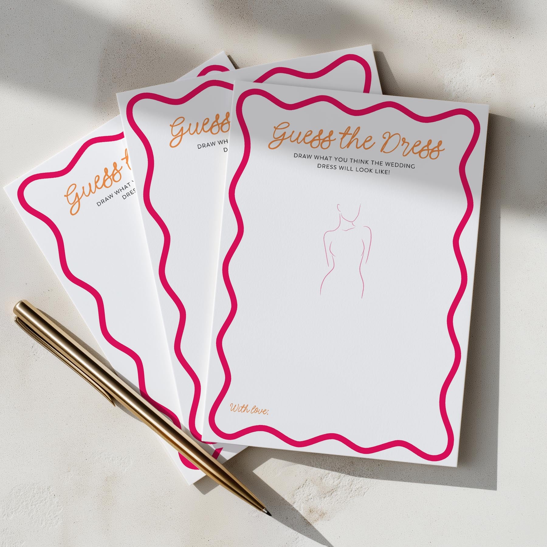 Three 'Guess the Dress' cards with a pen on a light surface