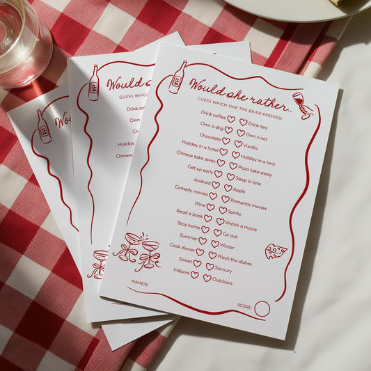 White cards with red text and graphics on a red and white checkered tablecloth.