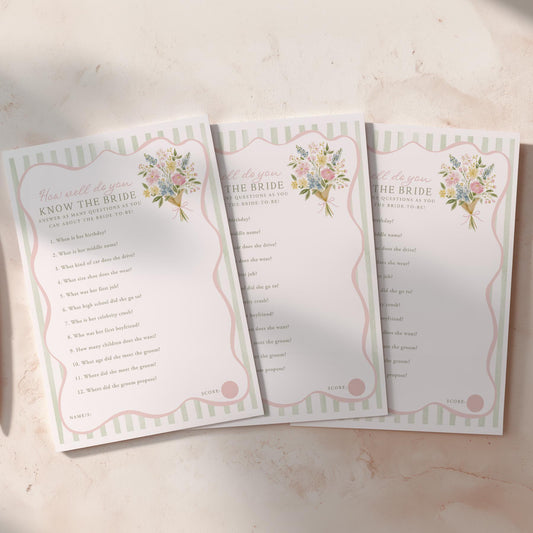 Three sheets of paper with floral designs and text on a light surface