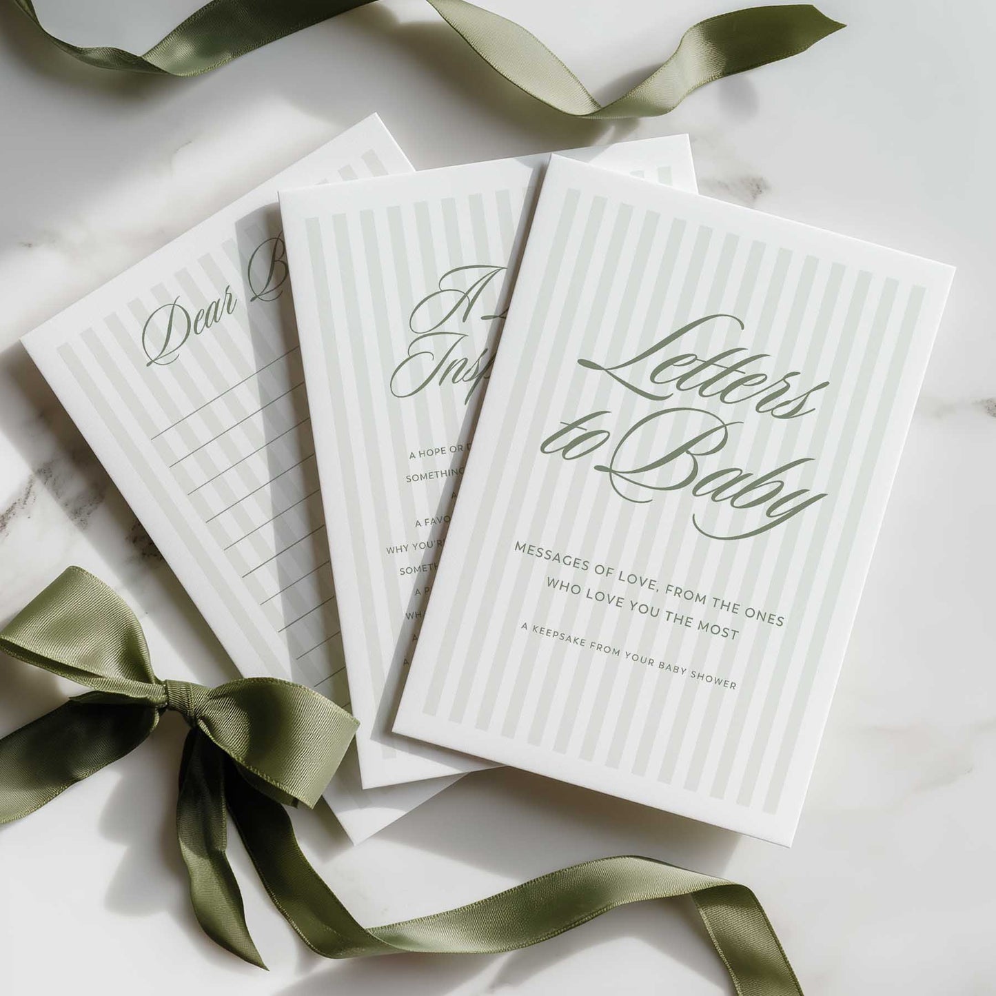 Sage Green Stripe Book titled 'Letters to Baby' with green ribbons on a light surface