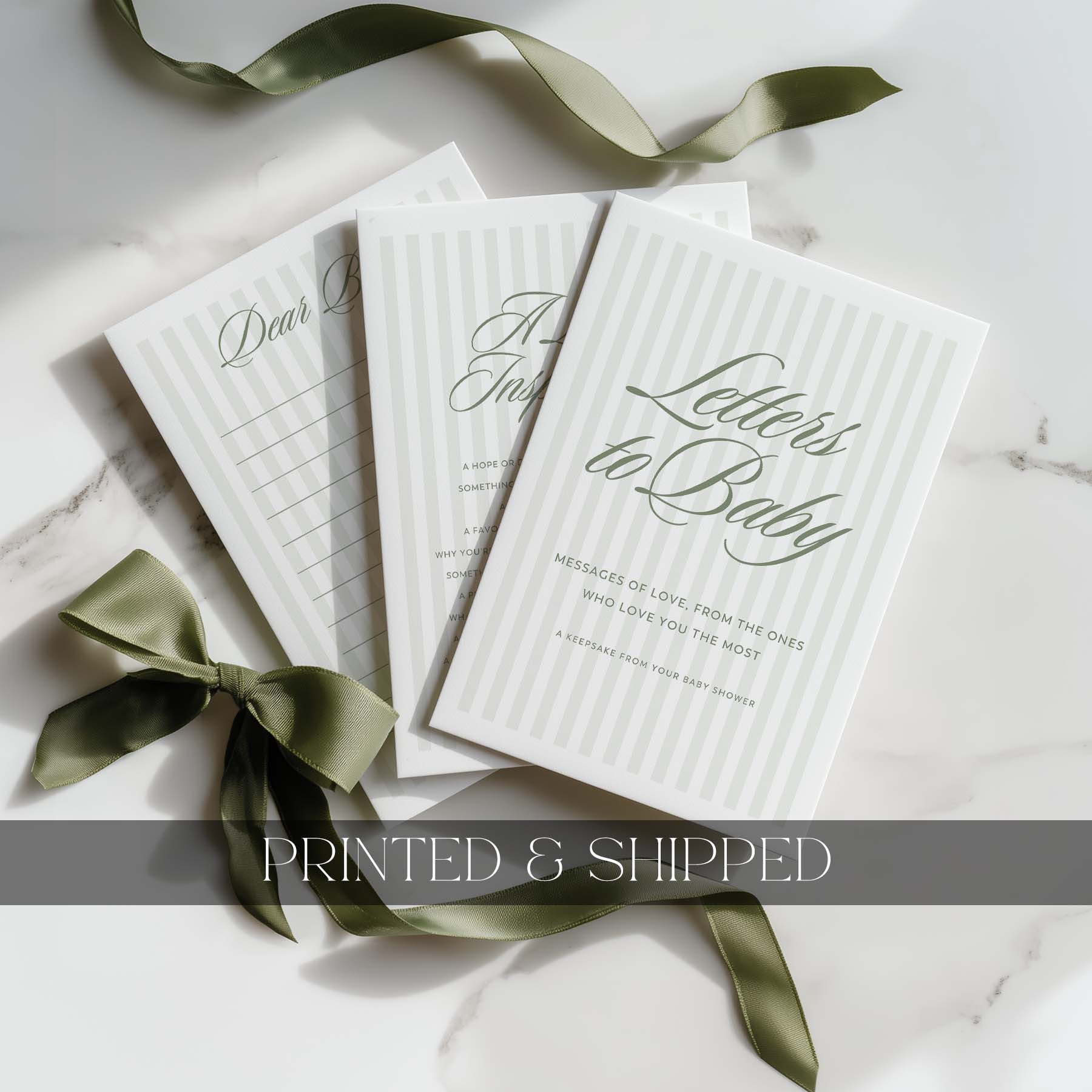Set of 'Letters to Baby' books with green stripe ribbons on a light background