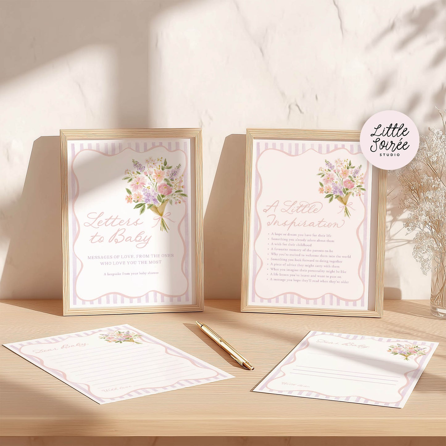 Two framed prints with floral designs and text on a wooden surface, featuring the brand 'Little Sorree'.