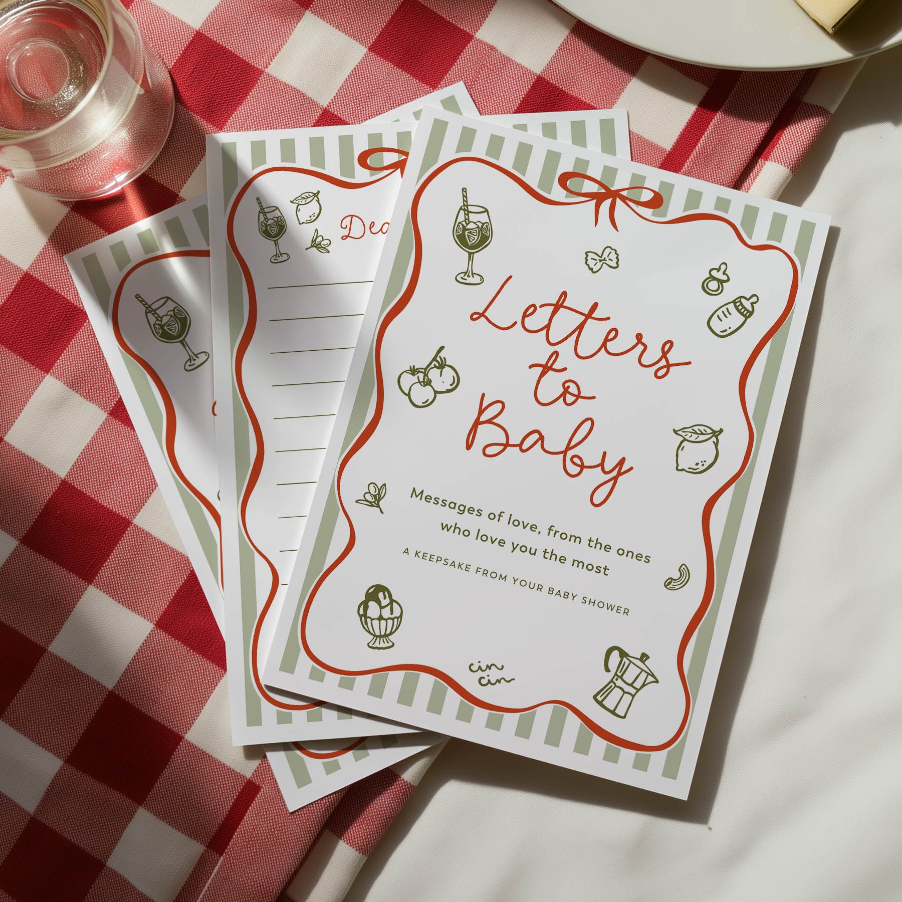 Printed baby shower games titled 'Letters to Baby' on a red and white checkered tablecloth. ciao baby green red design