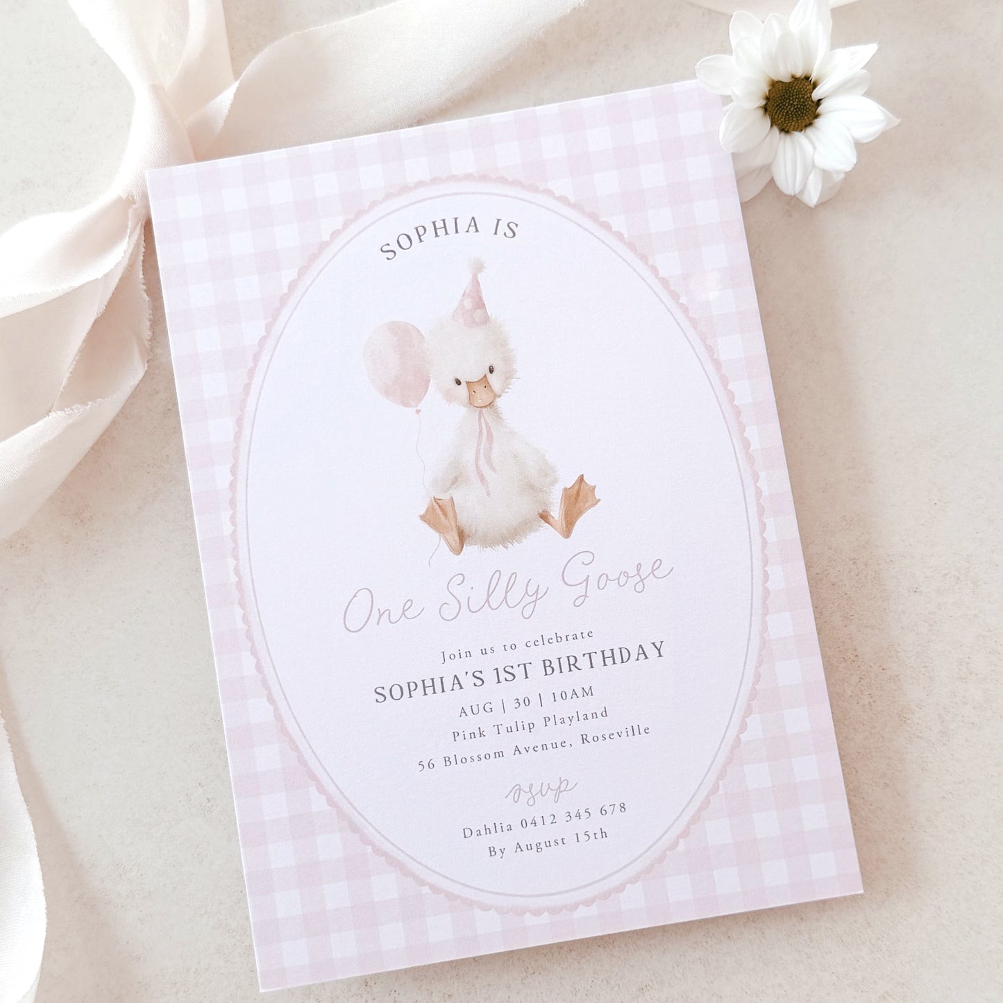 Invitation card for a baby's 1st birthday with a goose illustration on a light pink background.