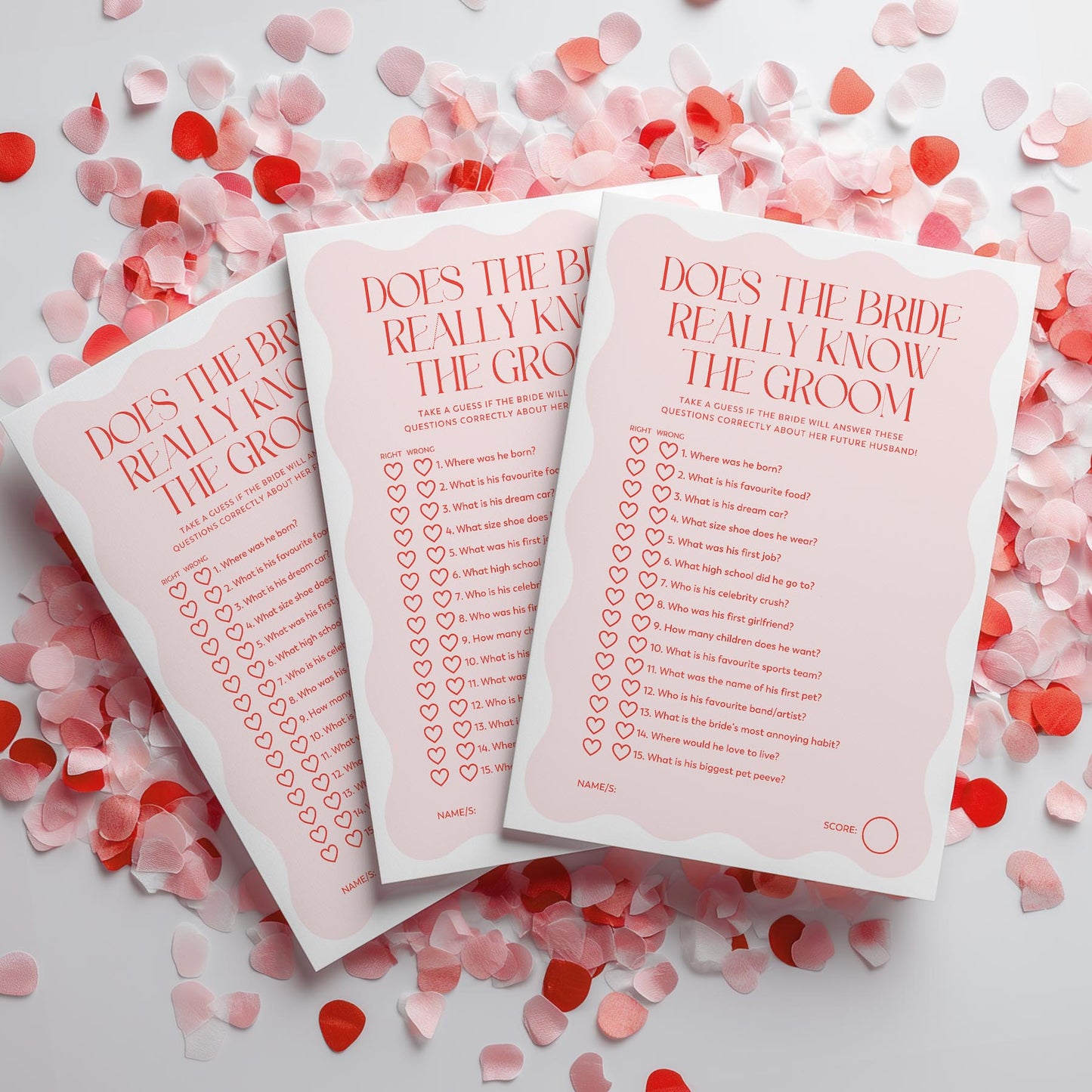 Three 'Does the Bride Really Know the Groom' question cards on a white background with red and pink confetti.