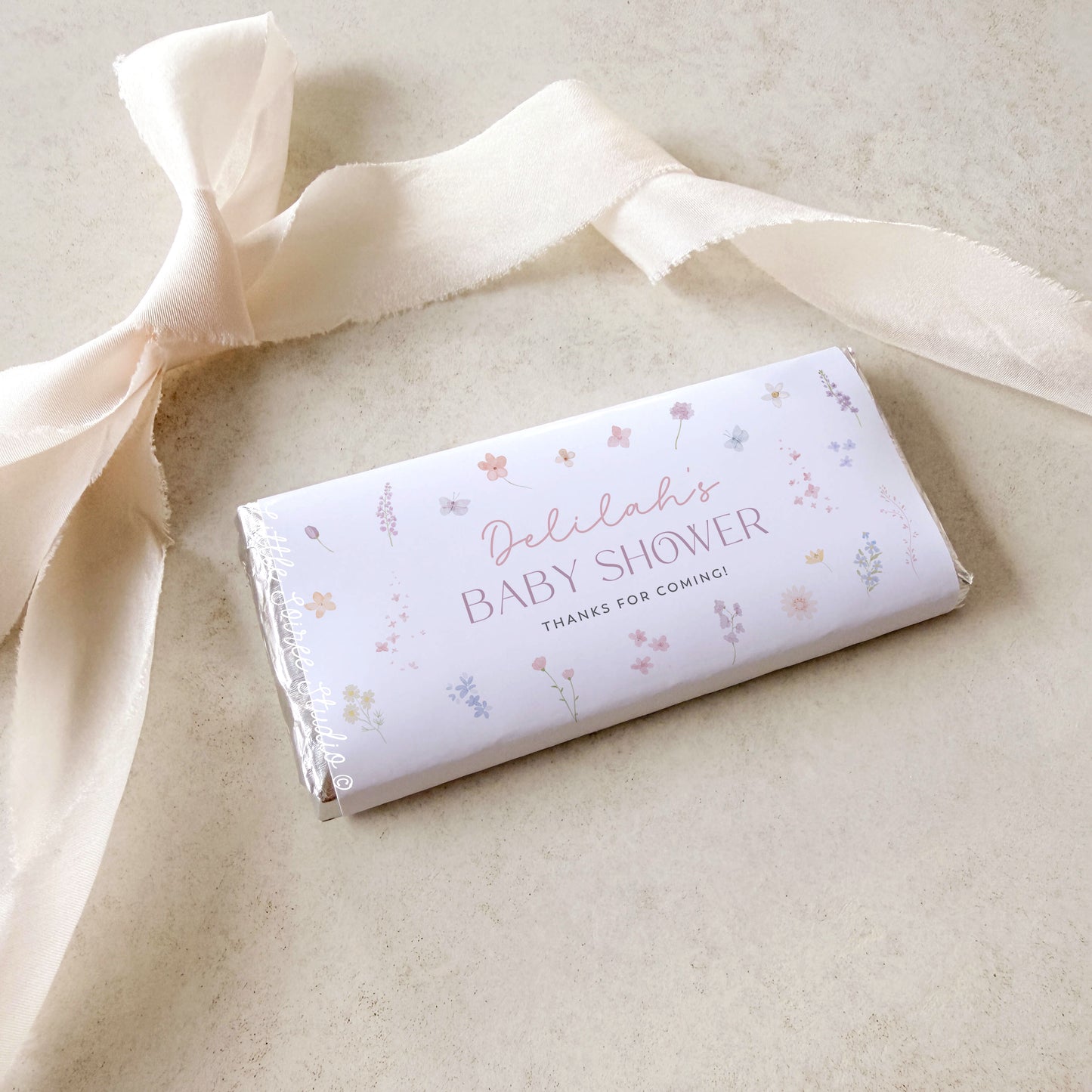 Chocolate bar with 'Delilah's Baby Shower' text on a light background
