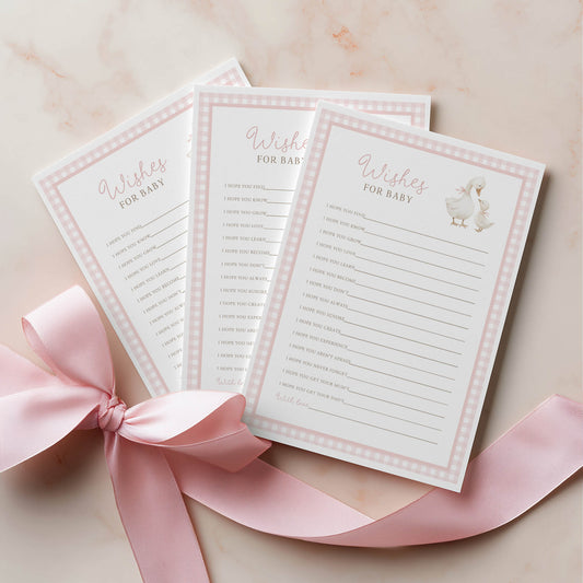 Three baby shower prediction and advice cards with a pink ribbon on a light background