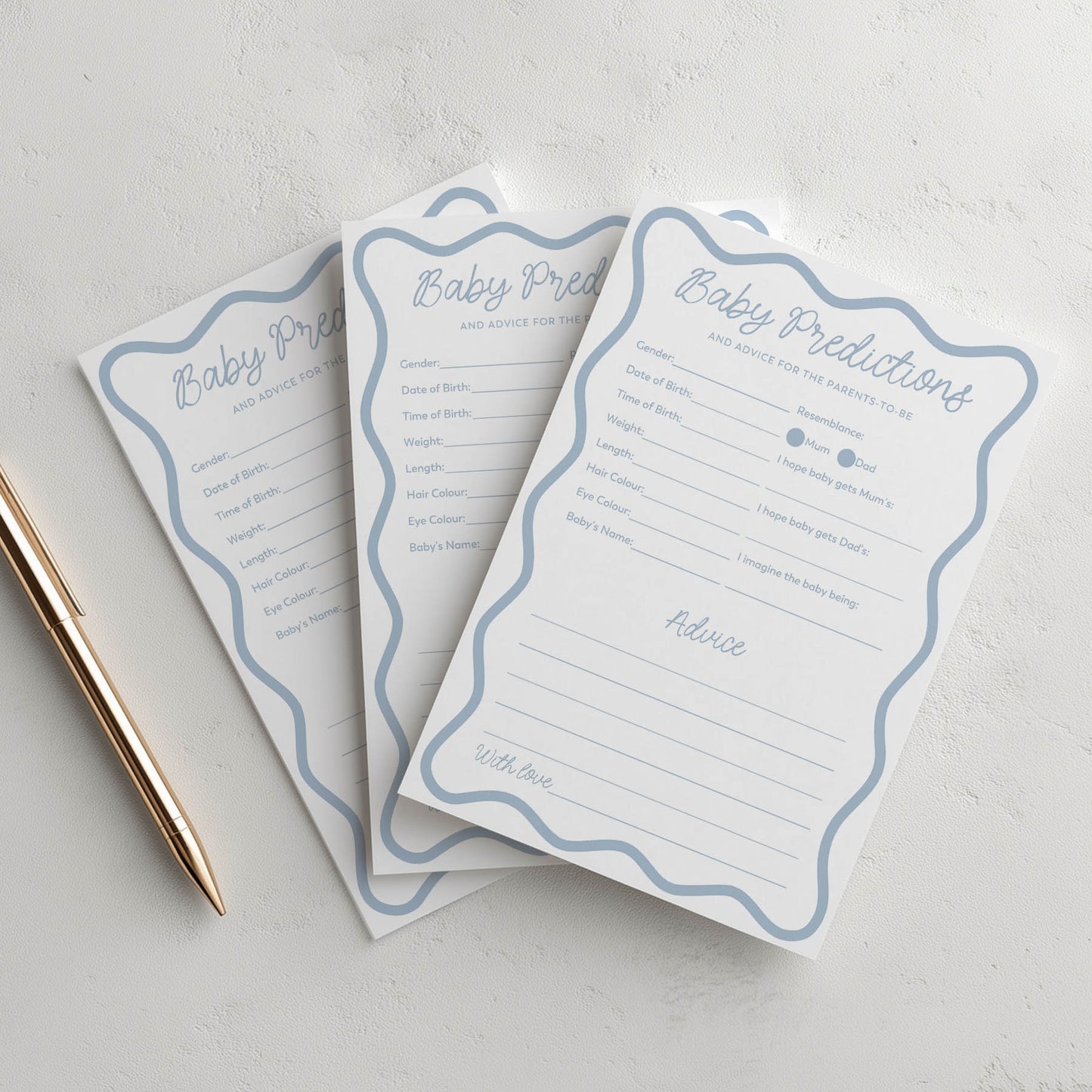 Three blue wavy baby shower prediction cards with a pen on a light gray background