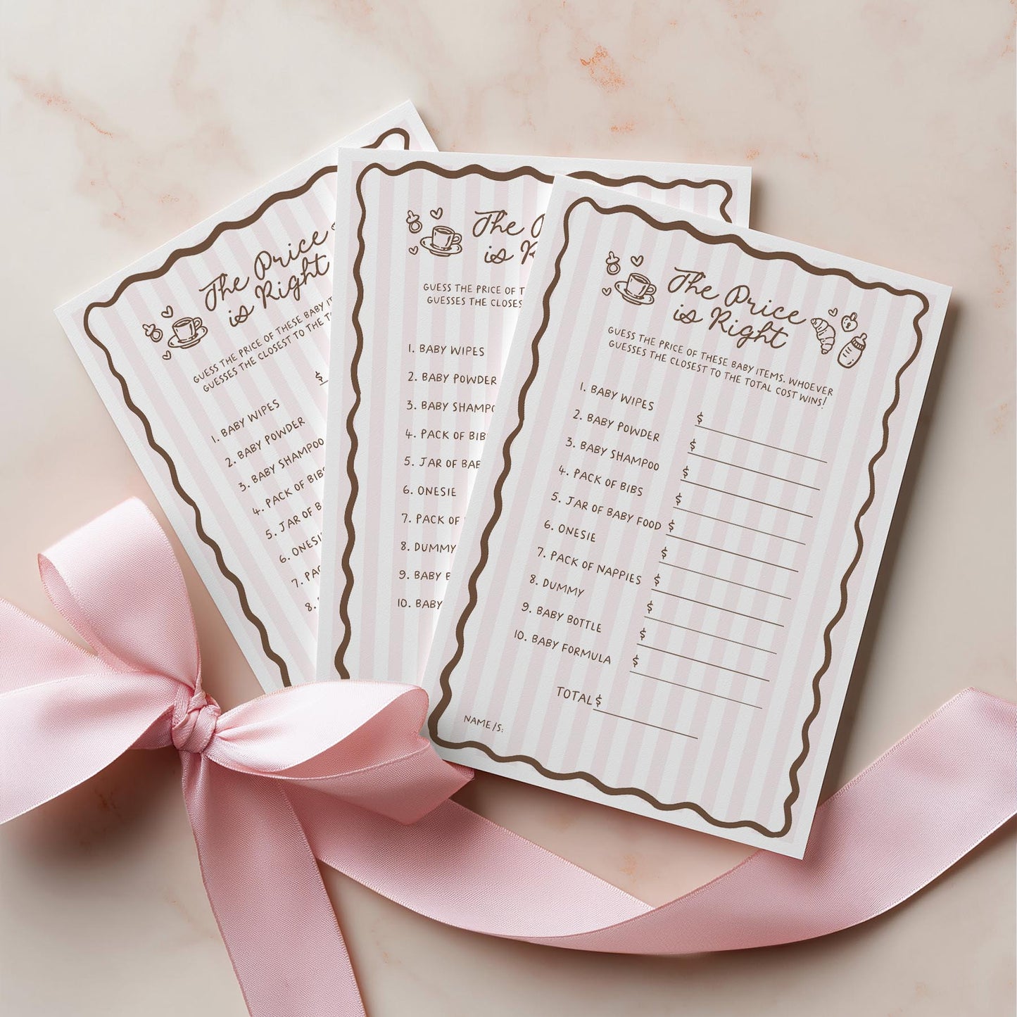 Two 'The Price is Right' game cards for a baby shower on a pink ribbon with a pink background.