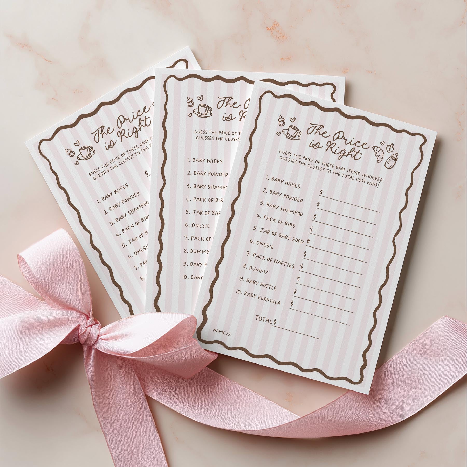 Two 'The Price is Right' game cards for a baby shower on a pink ribbon with a pink background.