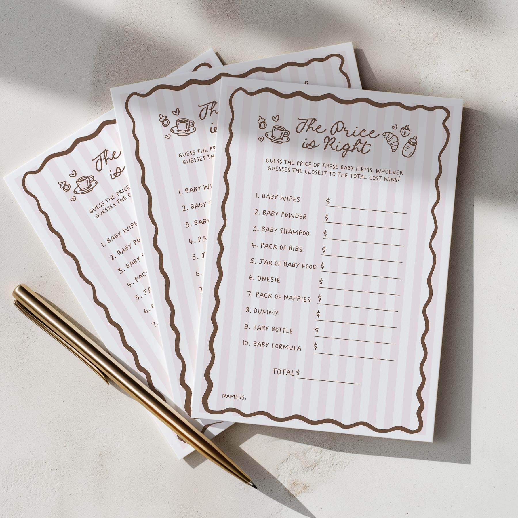 Two 'The Price is Right' baby shower game sheets with a pen on a light surface.