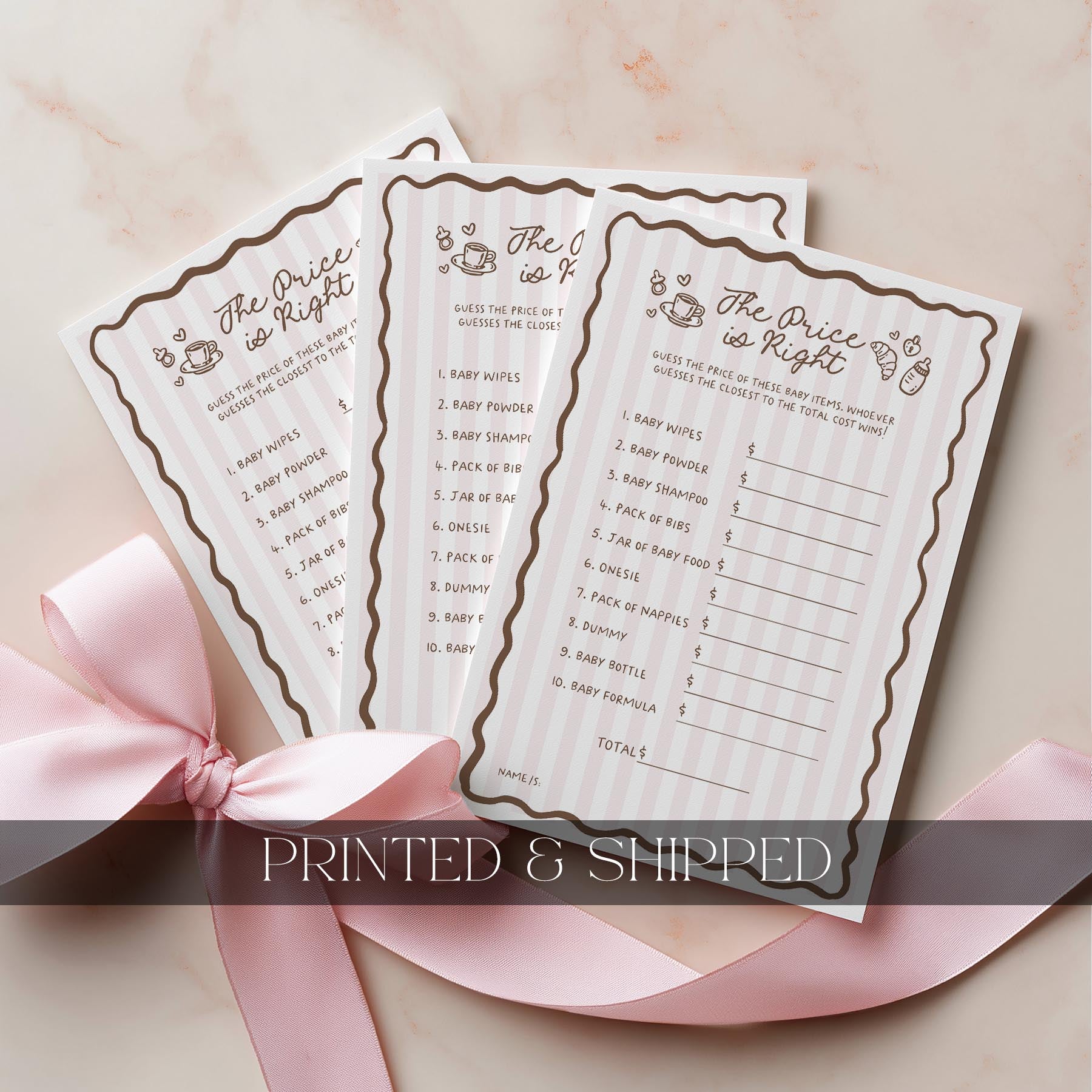 Three baby prediction and advice cards with a pink ribbon on a light background