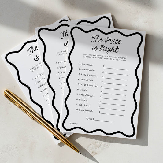 Three 'The Price is Right' game cards for a baby shower on a light surface with a gold pen.