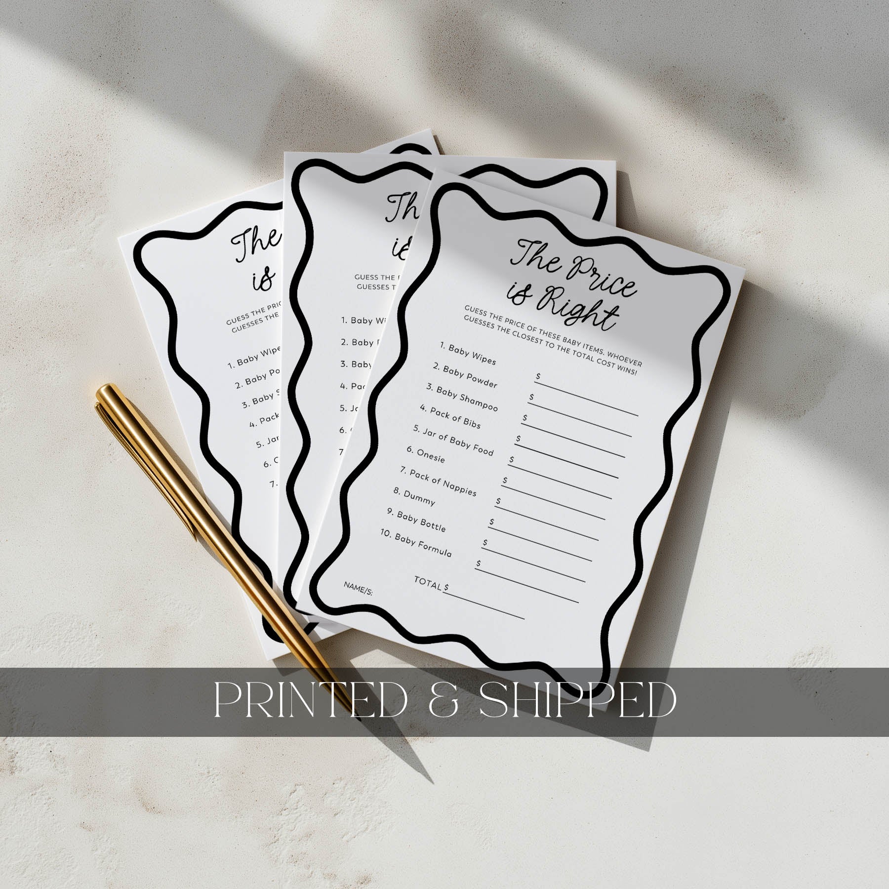 Three 'The Price is Right' game sheets on a light surface with a gold pen.