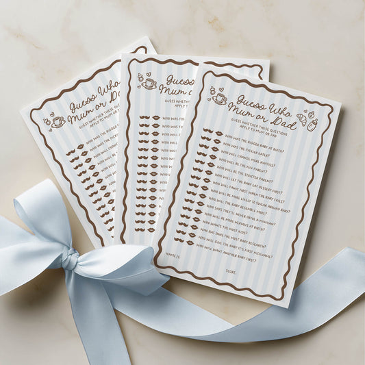 Three baby shower game cards with lip and mustache designs on a beige background with a blue ribbon.