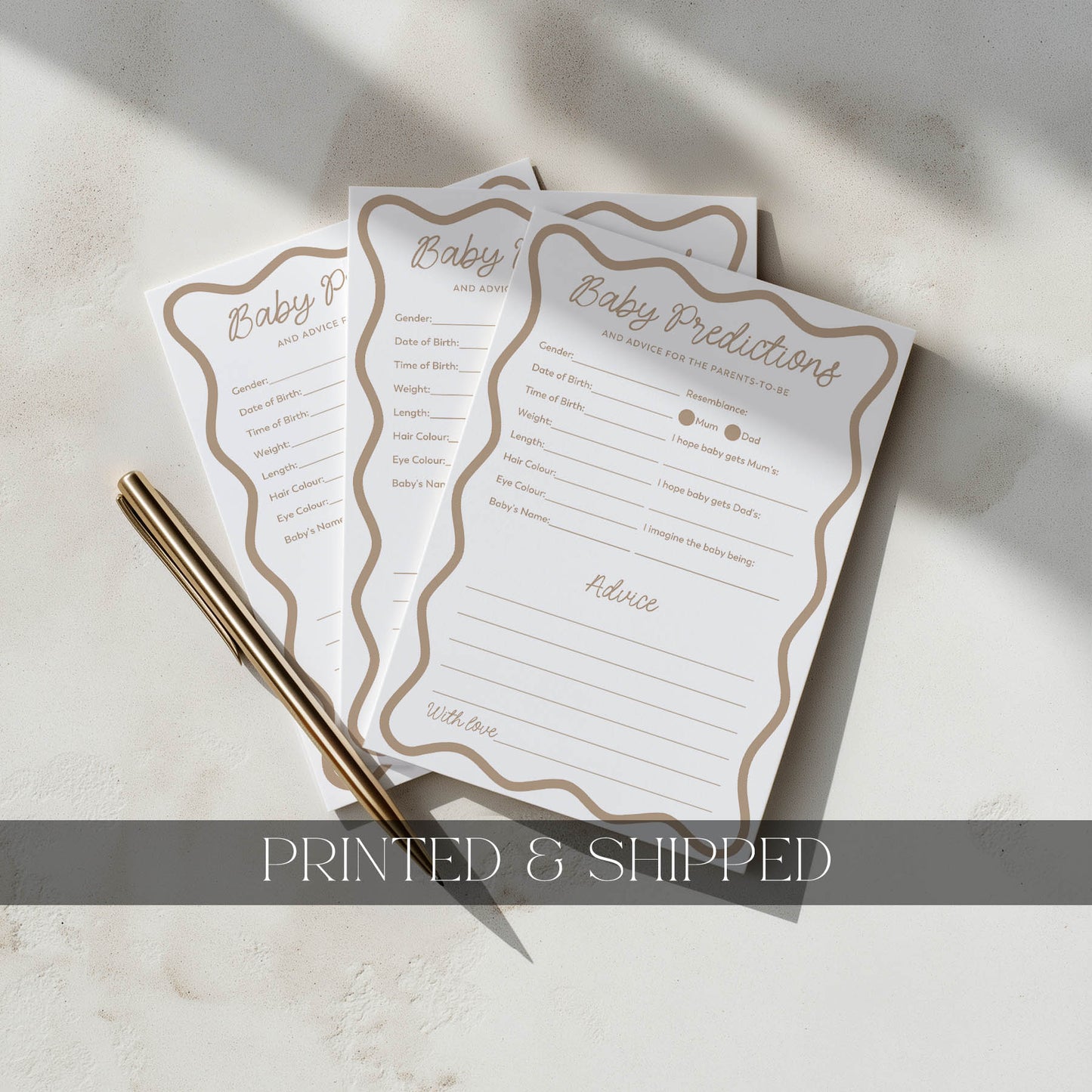 Three baby shower prediction cards with a pen on a light surface, labeled 'Printed & Shipped'.