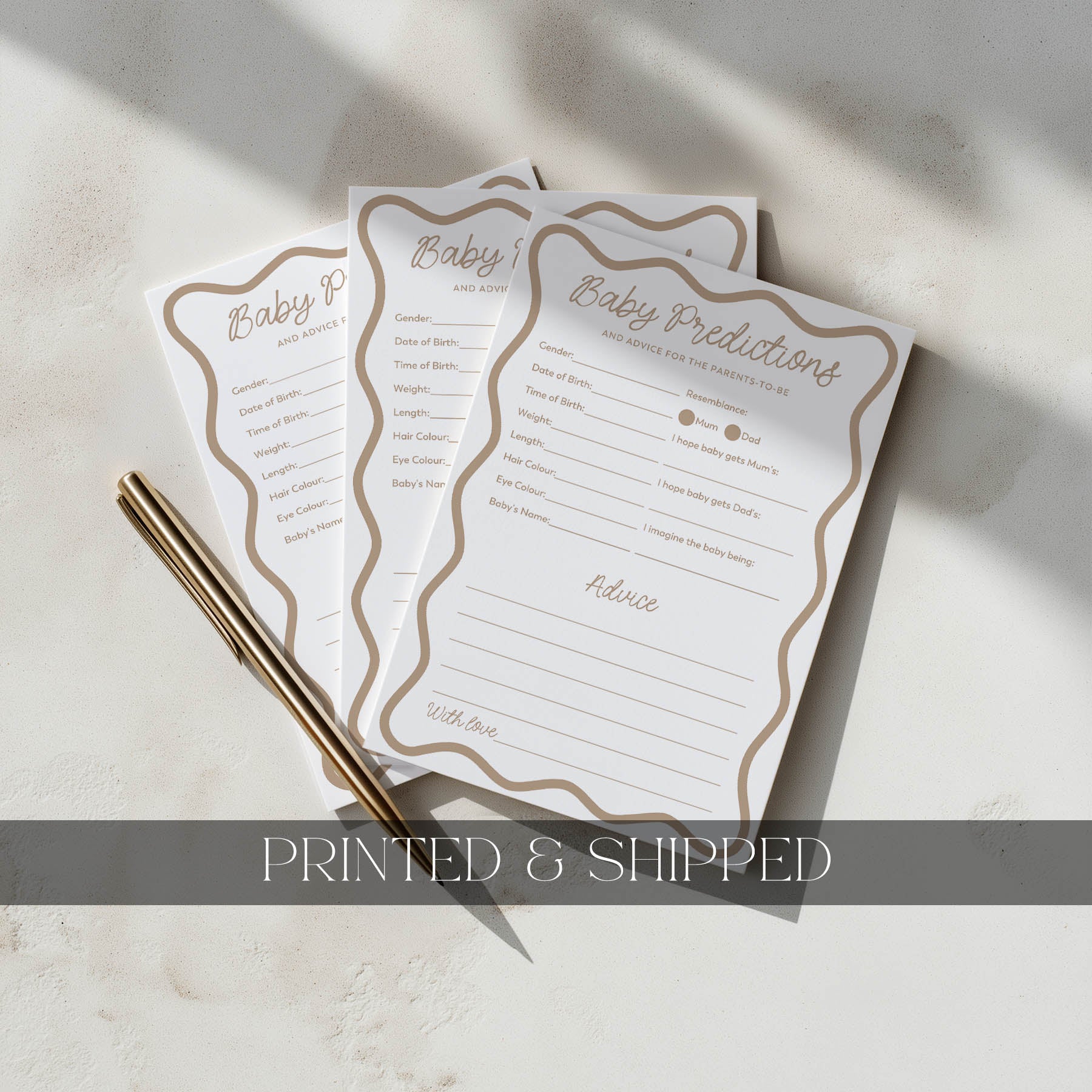 Three baby shower prediction cards with a pen on a light surface, labeled 'Printed & Shipped'.