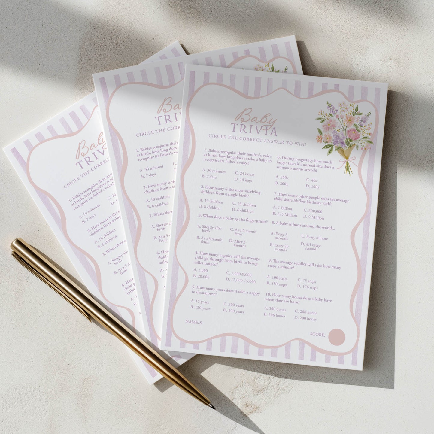 Two baby trivia cards with decorative elements on a light surface.