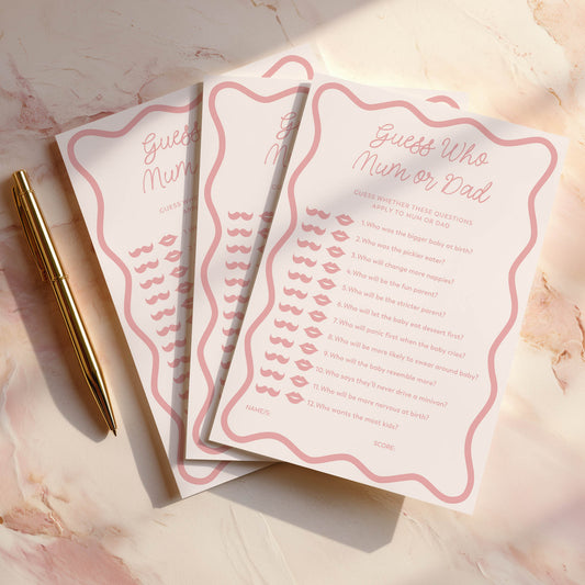 Three pink wavy baby shower game cards with a pen on a marble surface