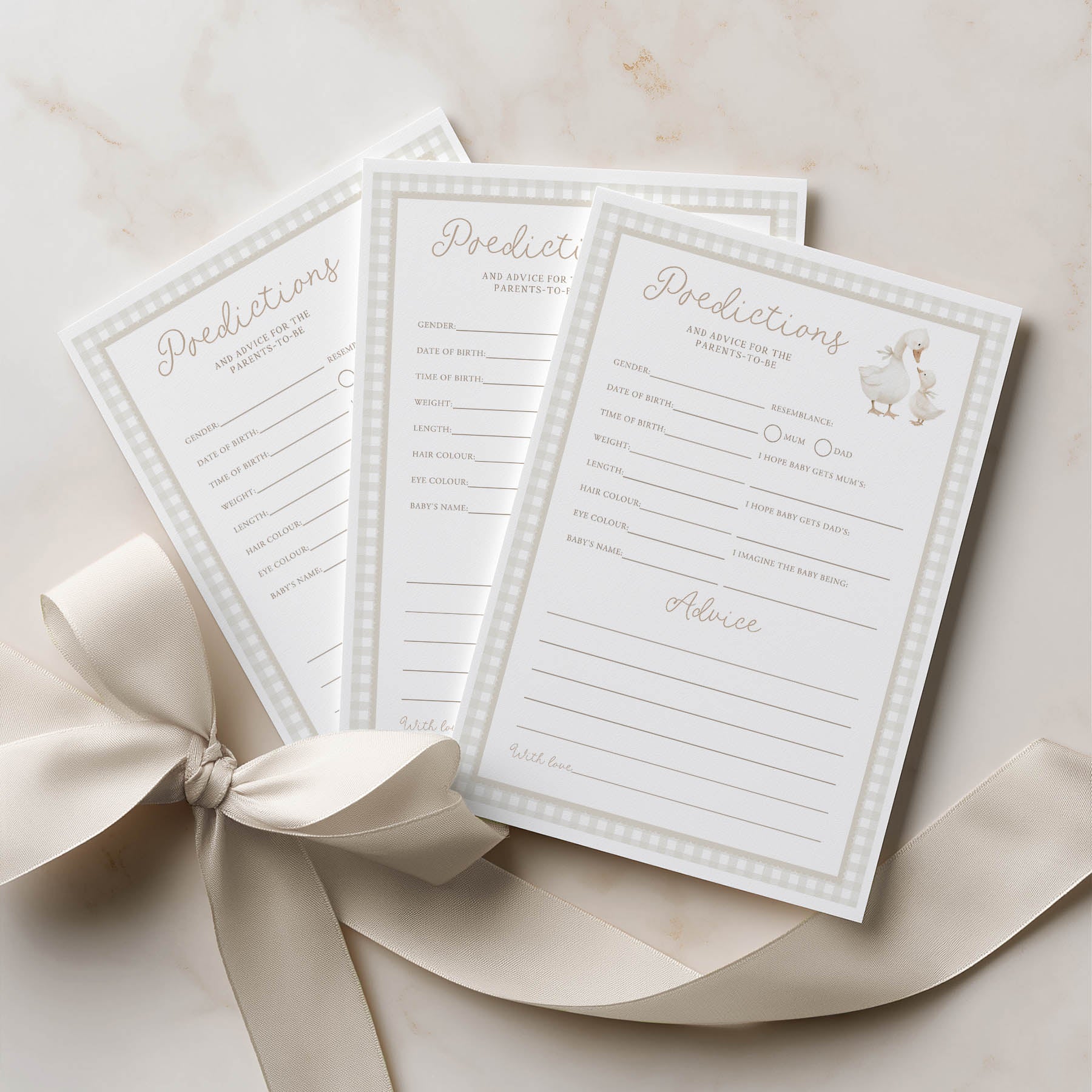 Three baby shower prediction cards with a decorative bow on a light background