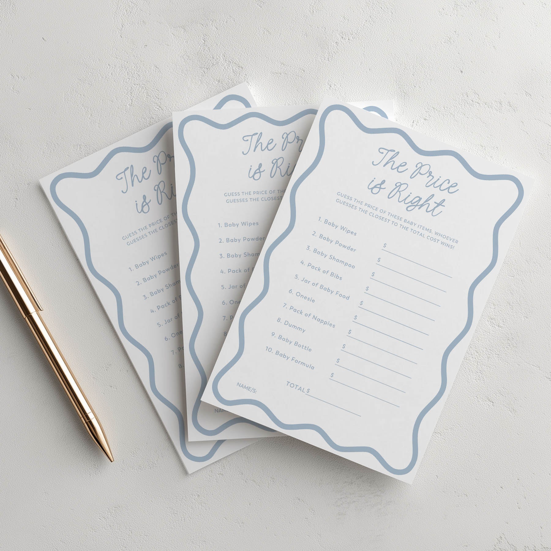 Three blue wavy 'The Price is Right' game sheets on a light gray surface with a pen.
