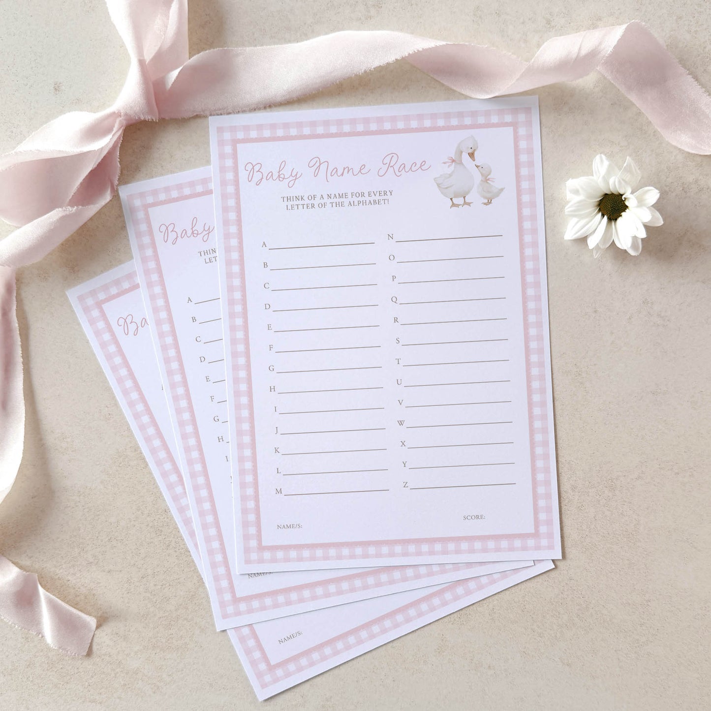 Baby name race game cards with pink ribbons and a flower on a beige background