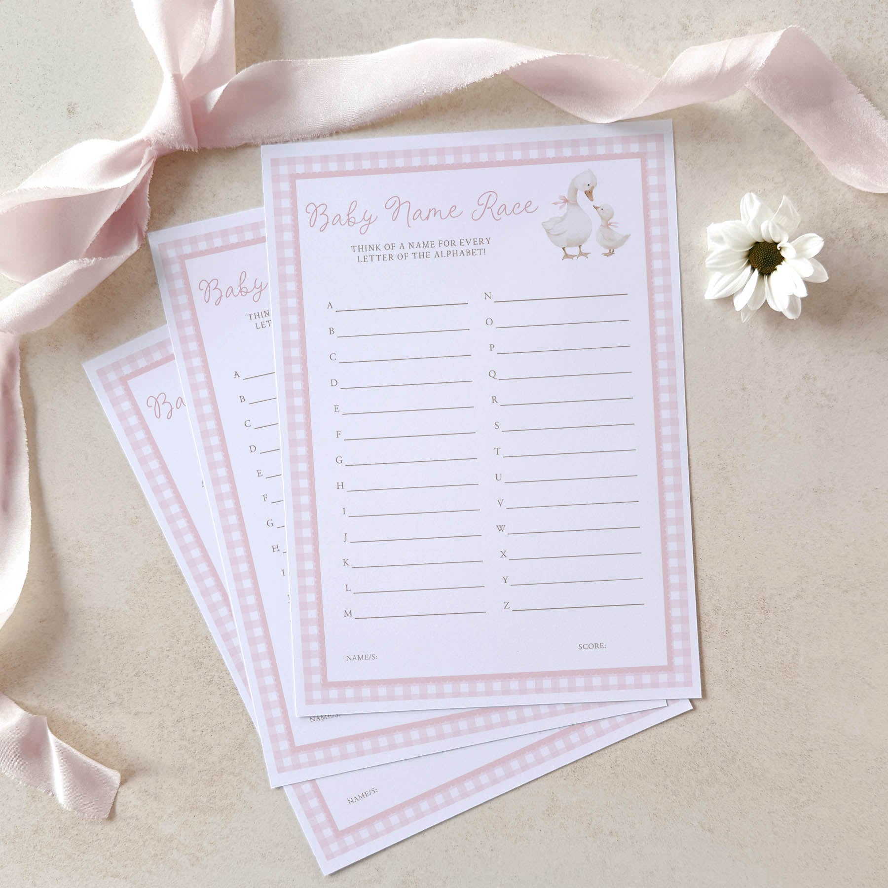 Baby name race game cards with pink ribbons and a flower on a beige background