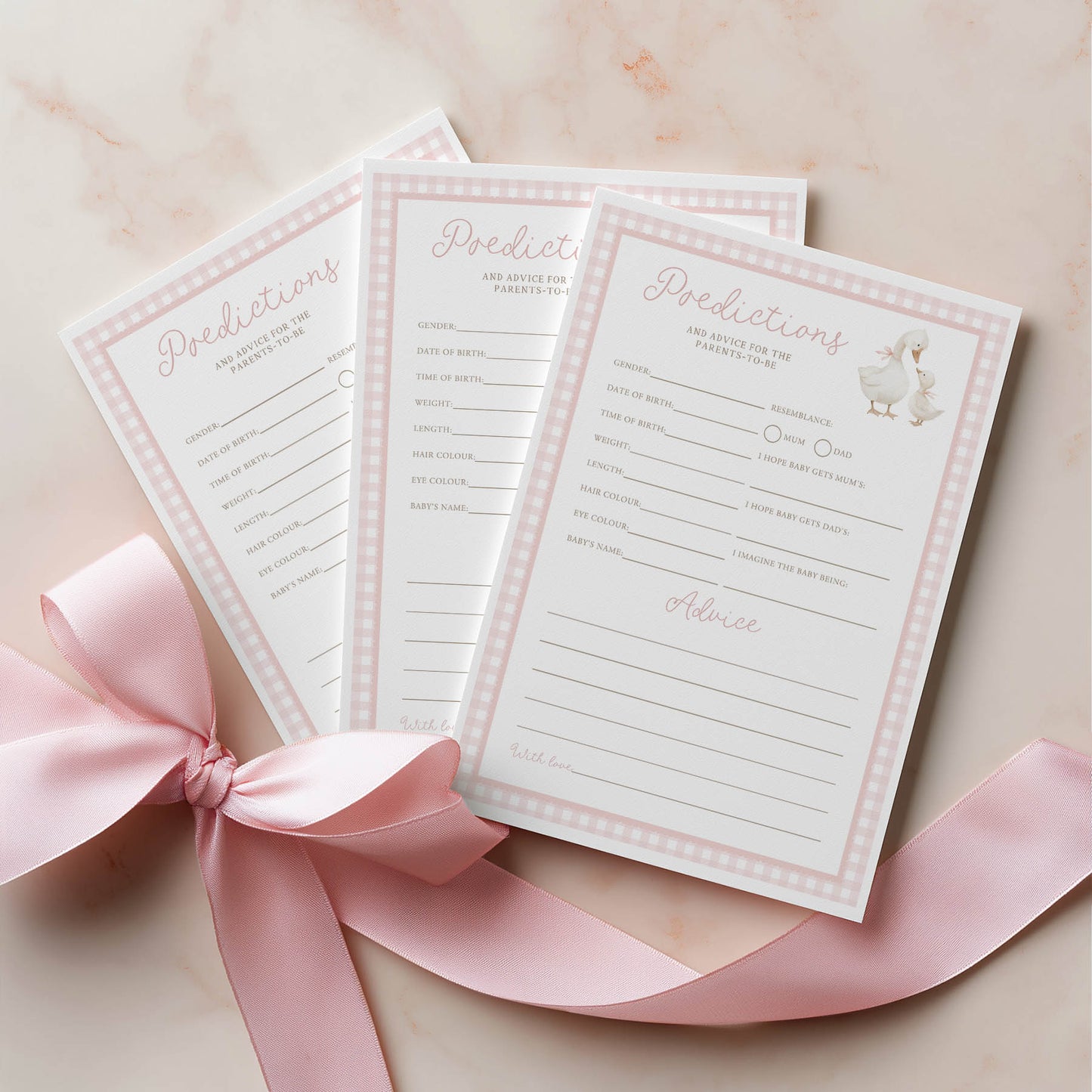Three baby shower prediction and advice cards with a pink ribbon on a light background