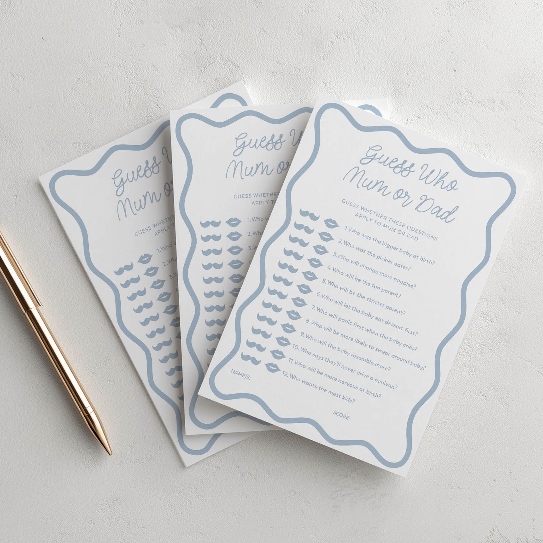 Three printed cards with blue text and decorative elements on a light gray surface.