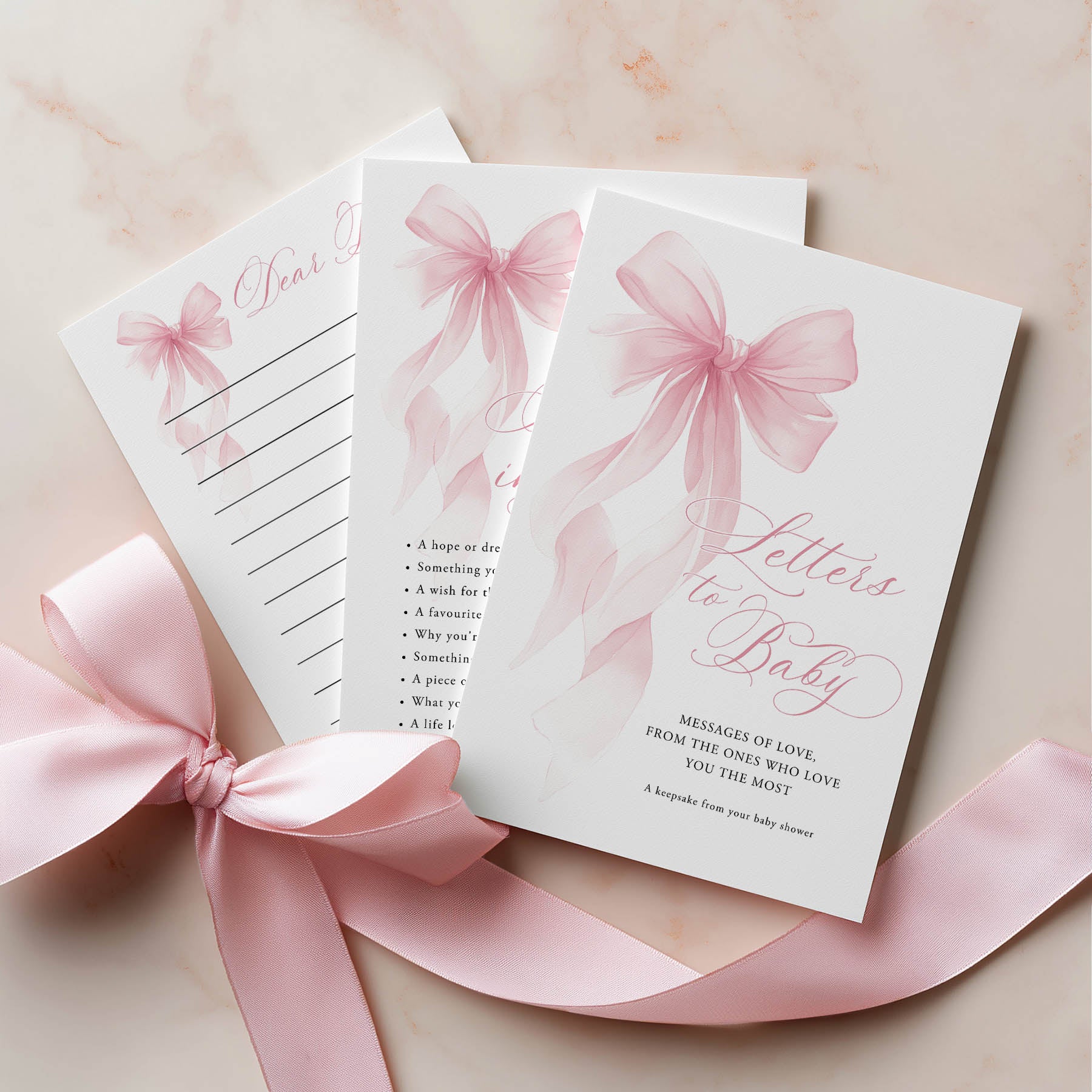 Stationery set with pink ribbons on a light background