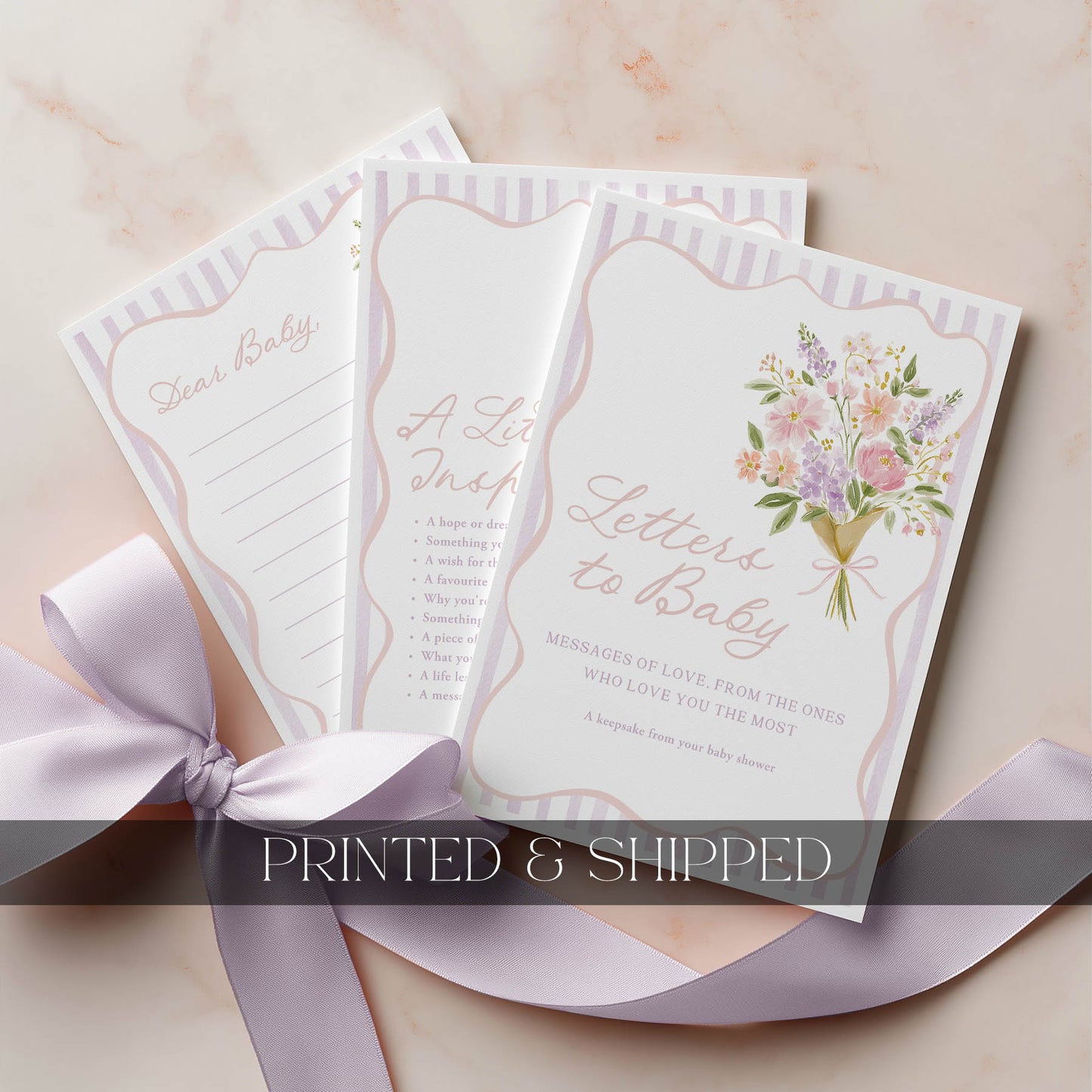 Set of baby shower cards with floral design and text on a light background