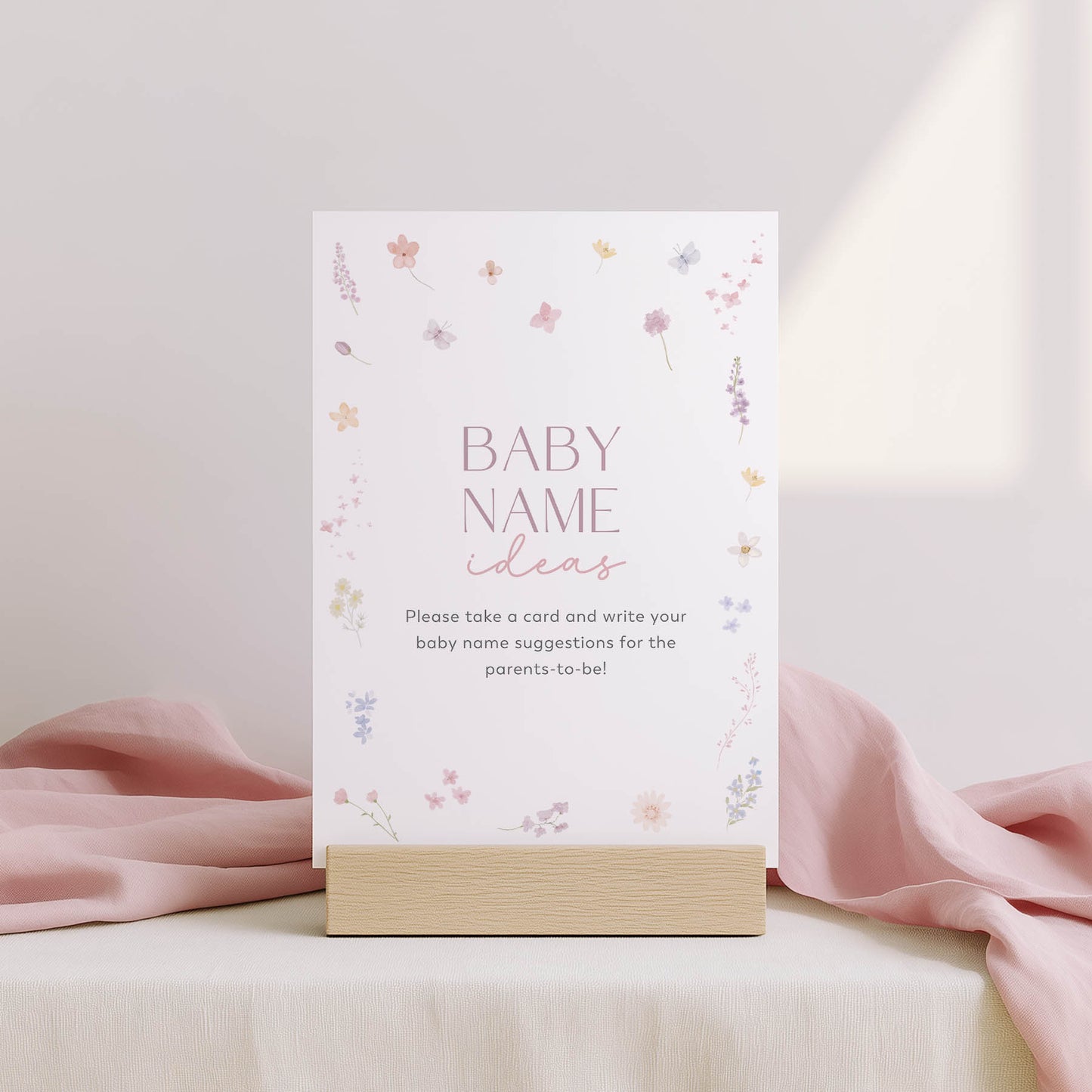 Card with 'Family traditions' text on a stand with floral design, against a light pink background.