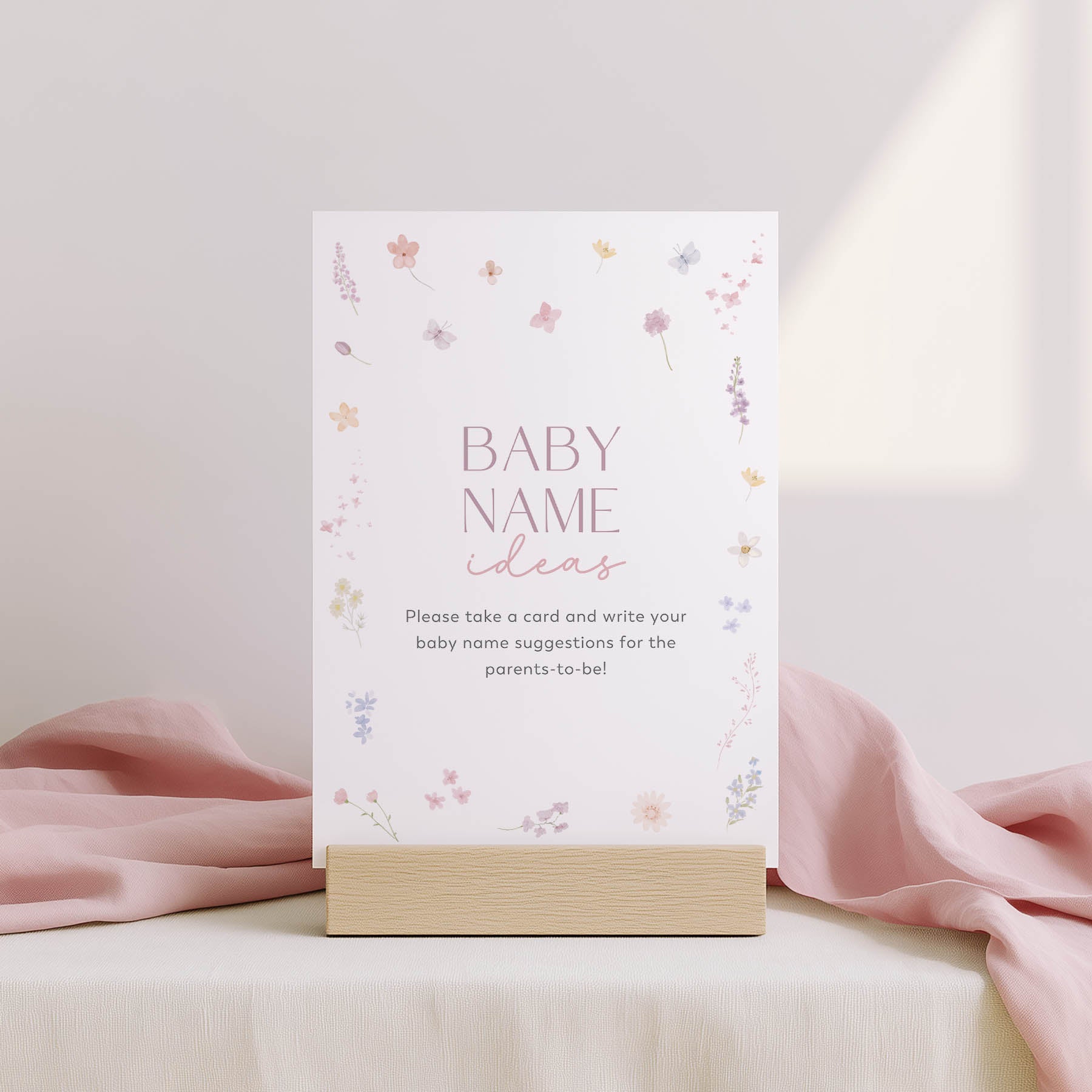 Card with 'Family traditions' text on a stand with floral design, against a light pink background.