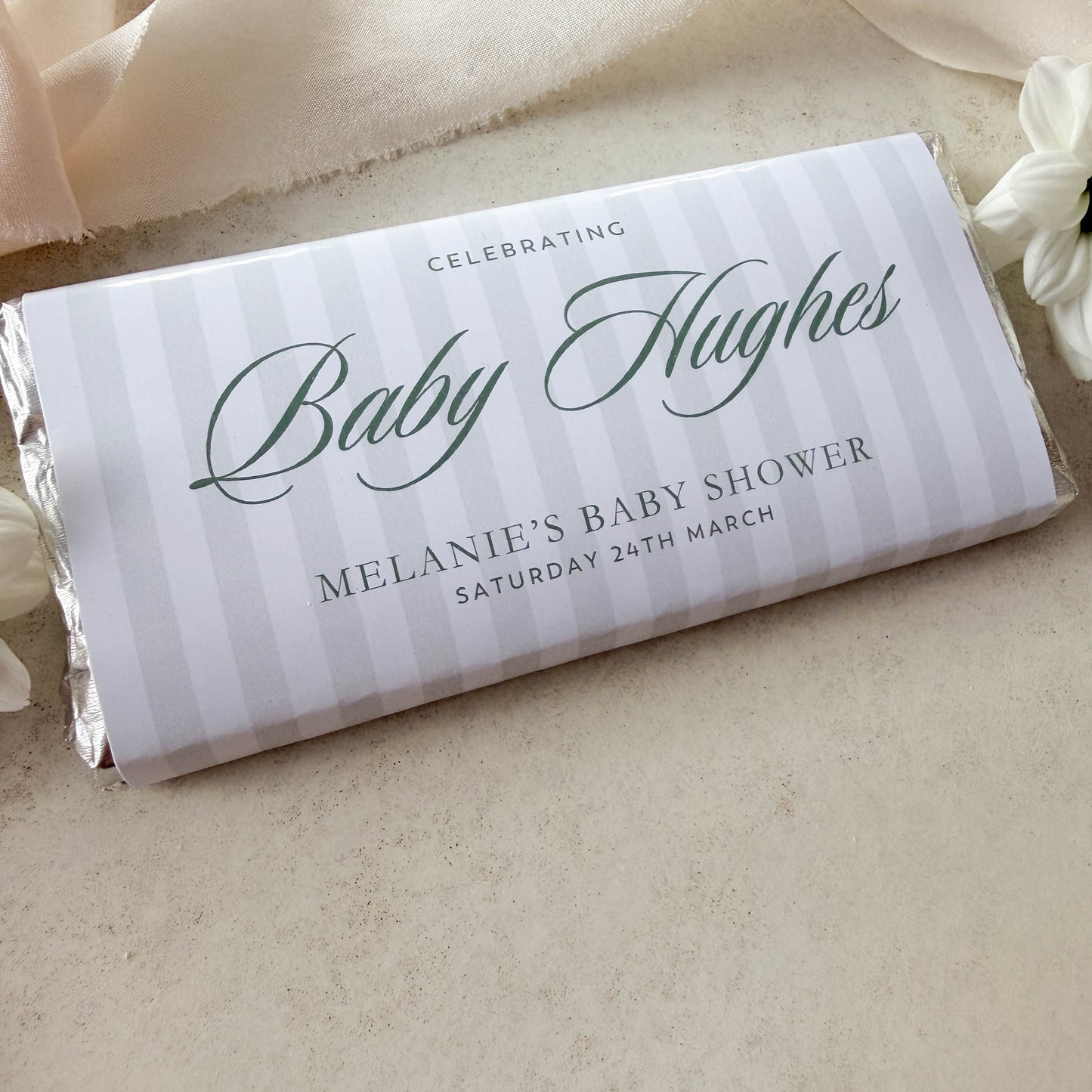 Personalized baby shower chocolate bar with decorative text on a neutral background