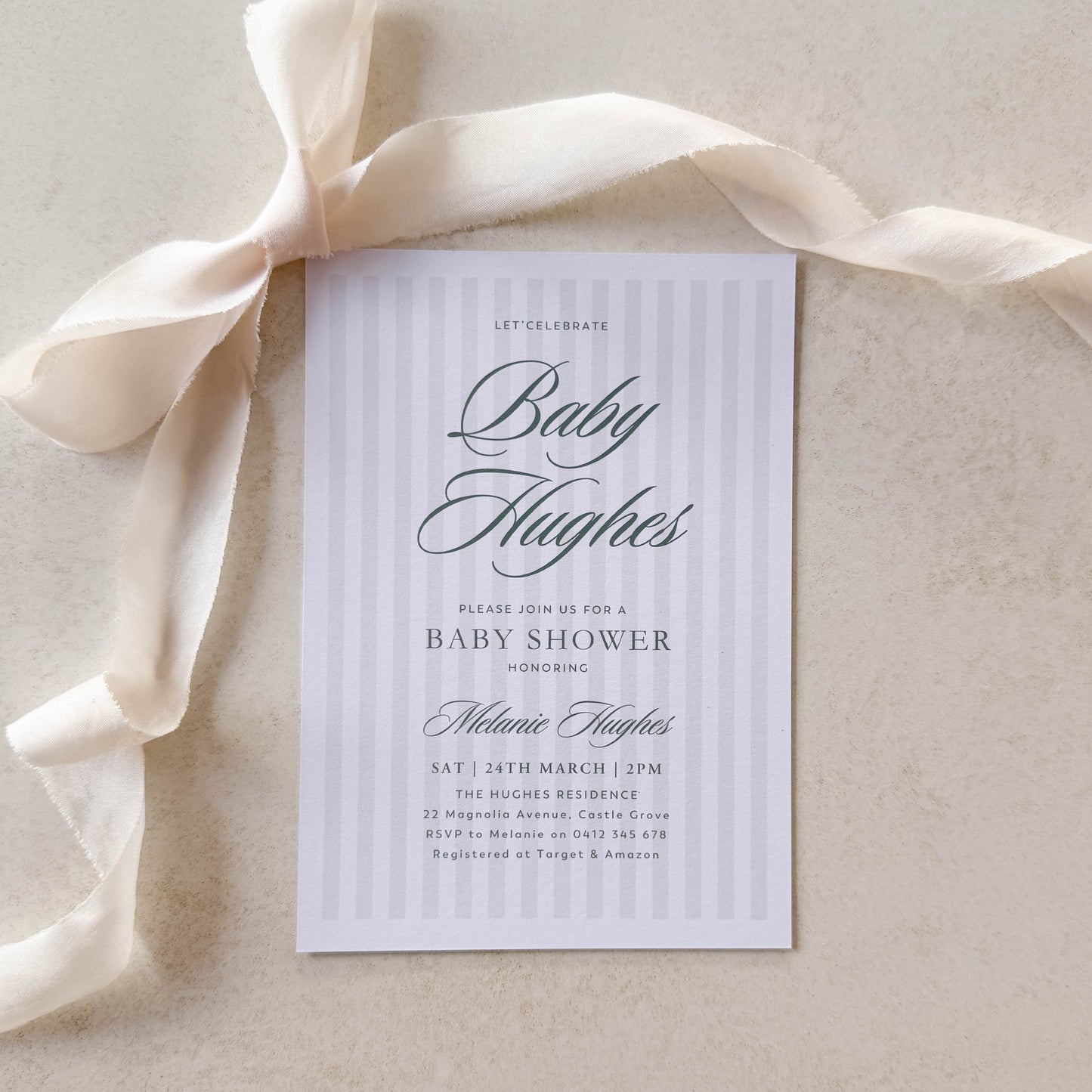 Baby shower invitation with a ribbon on a beige background