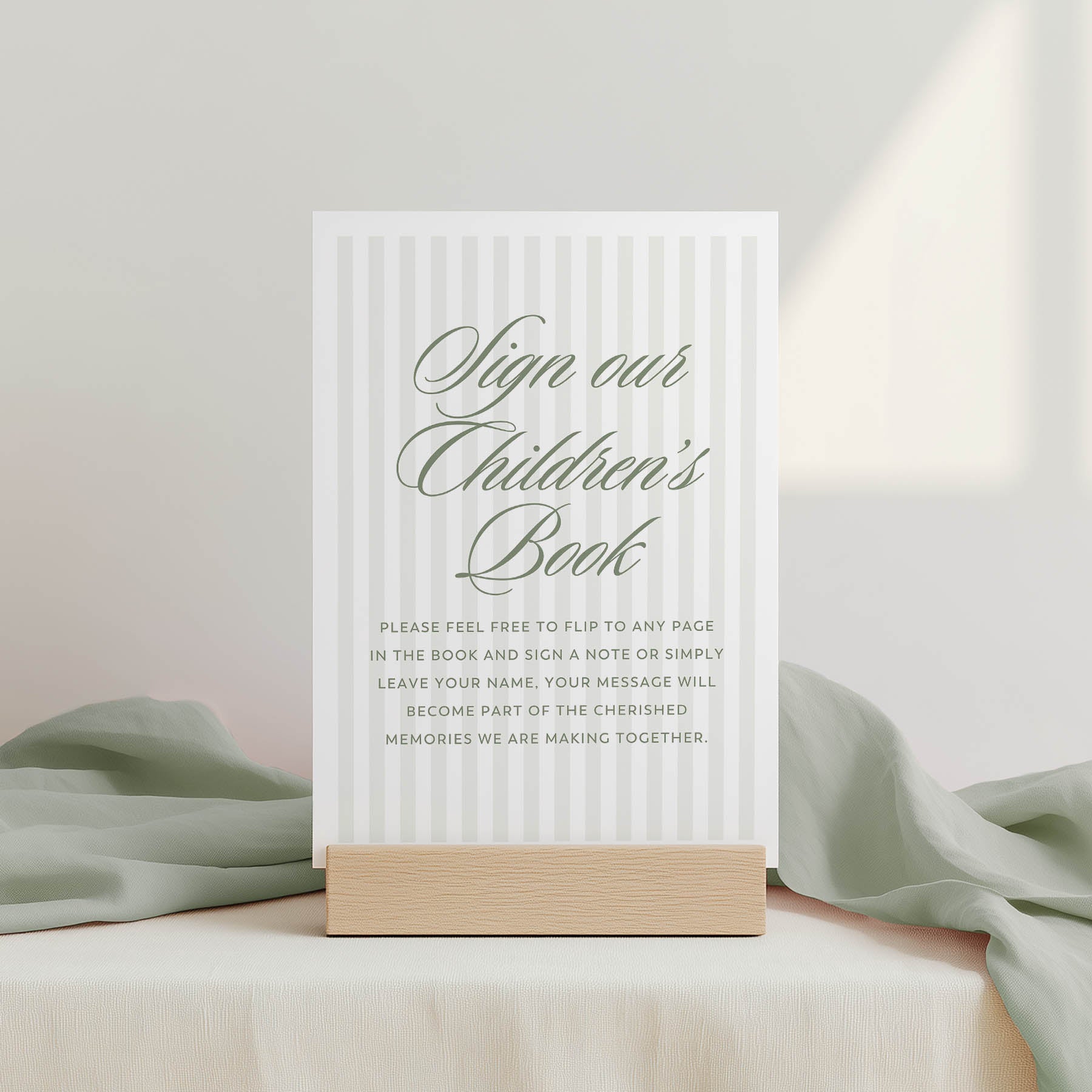White sign with text on a wooden stand against a light background