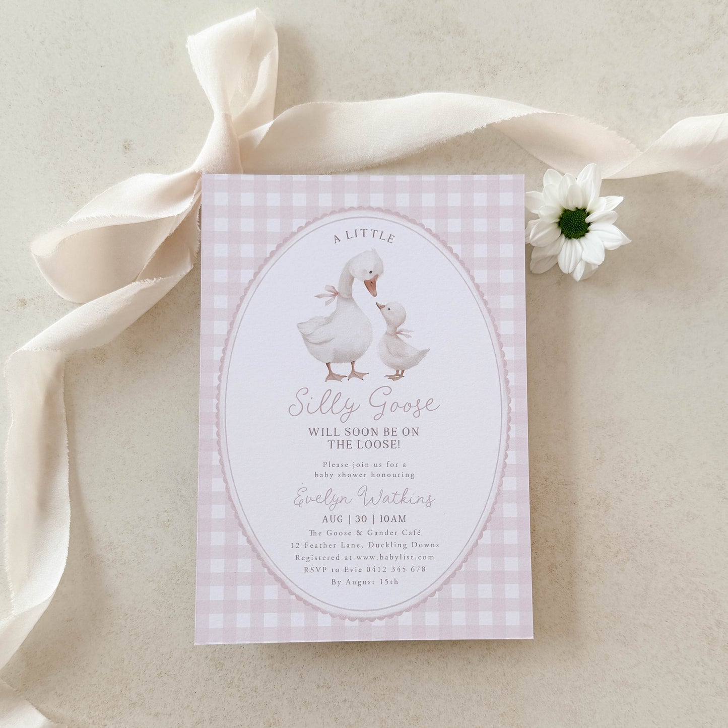 Silly Goose Baby Shower Invitation card with a goose illustration on a pink gingham background, surrounded by ribbons and a flower.