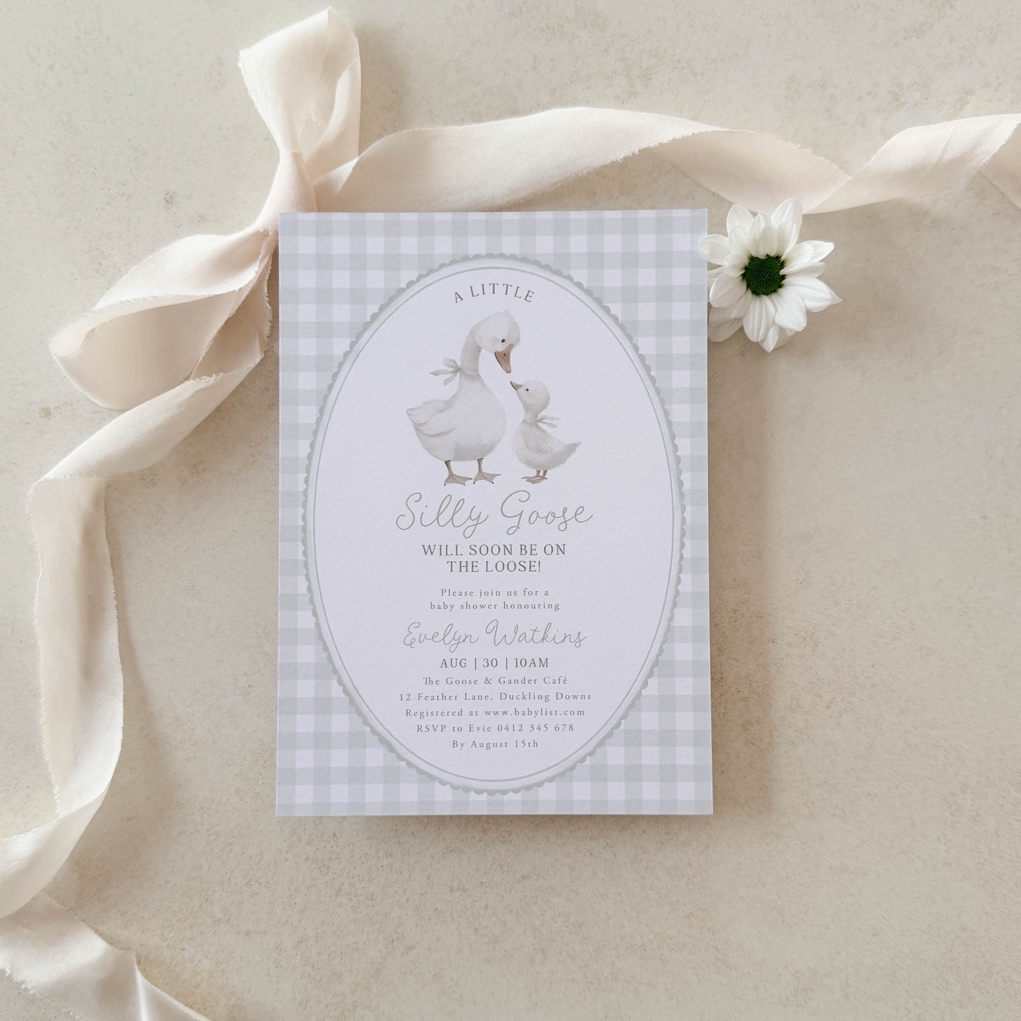 Silly Goose Green Baby shower invitation with a goose illustration on a green gingham background, surrounded by ribbons and a flower.