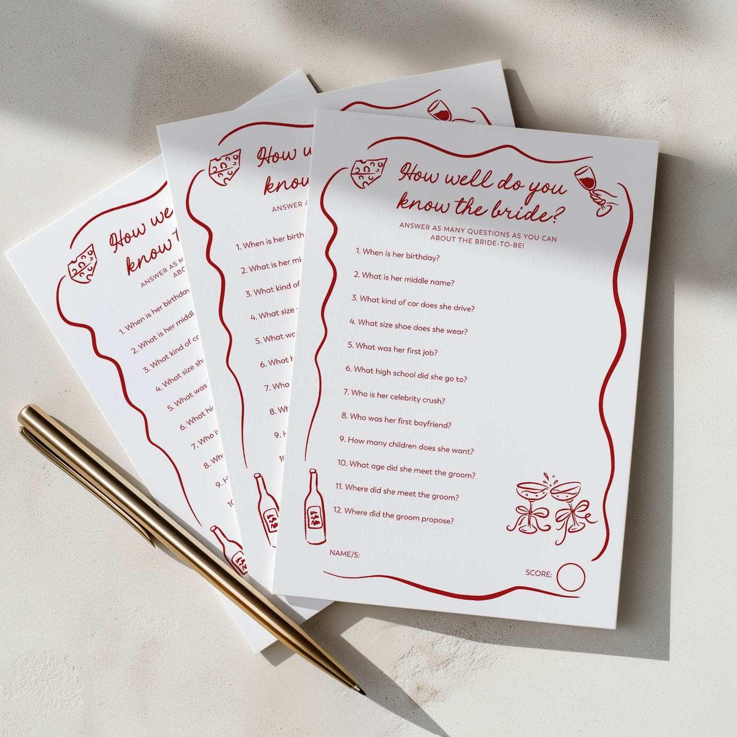 Three sheets of paper with bridal shower game questions on a light surface with a pen.