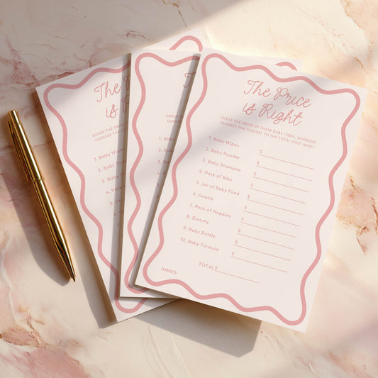 Set of Pink wavy 'The Price is Right' game cards with a gold pen on a marble surface