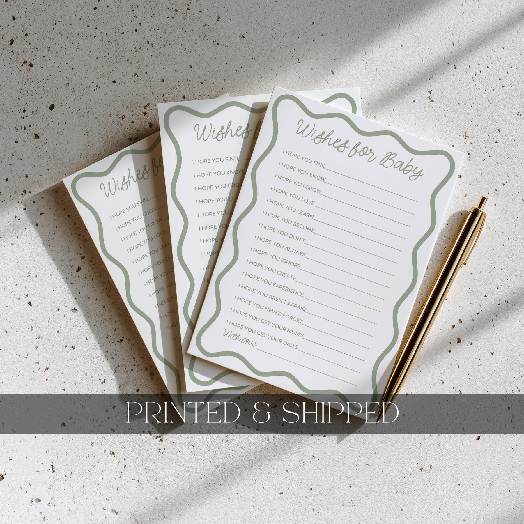 Three 'Wishes for Baby' cards with a pen on a textured surface, labeled 'Printed & Shipped'.