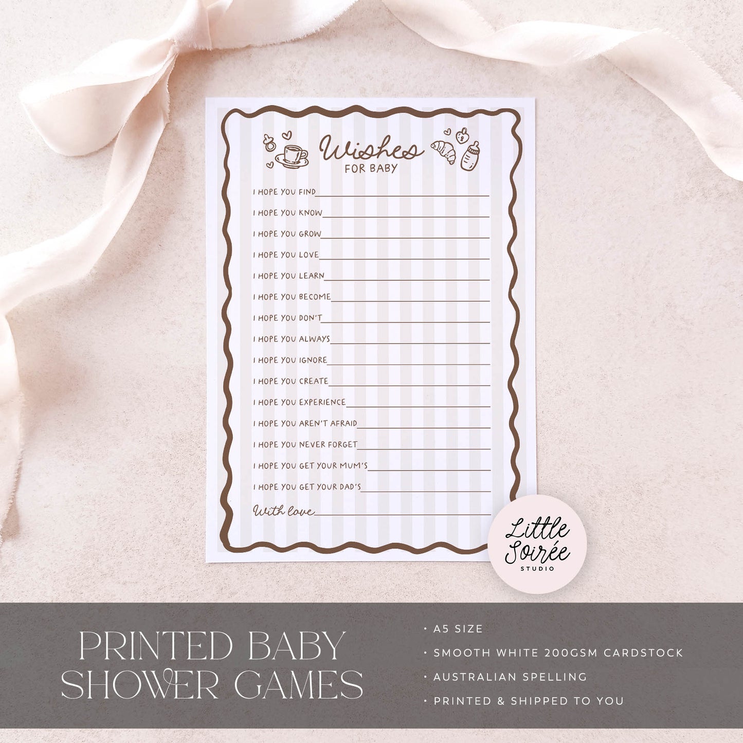 Baby shower game card on a soft fabric background with 'Little Sourie Studio' branding.