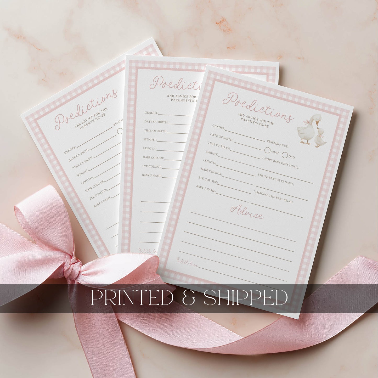 Three printed baby shower prediction and advice cards with a pink ribbon on a light background.