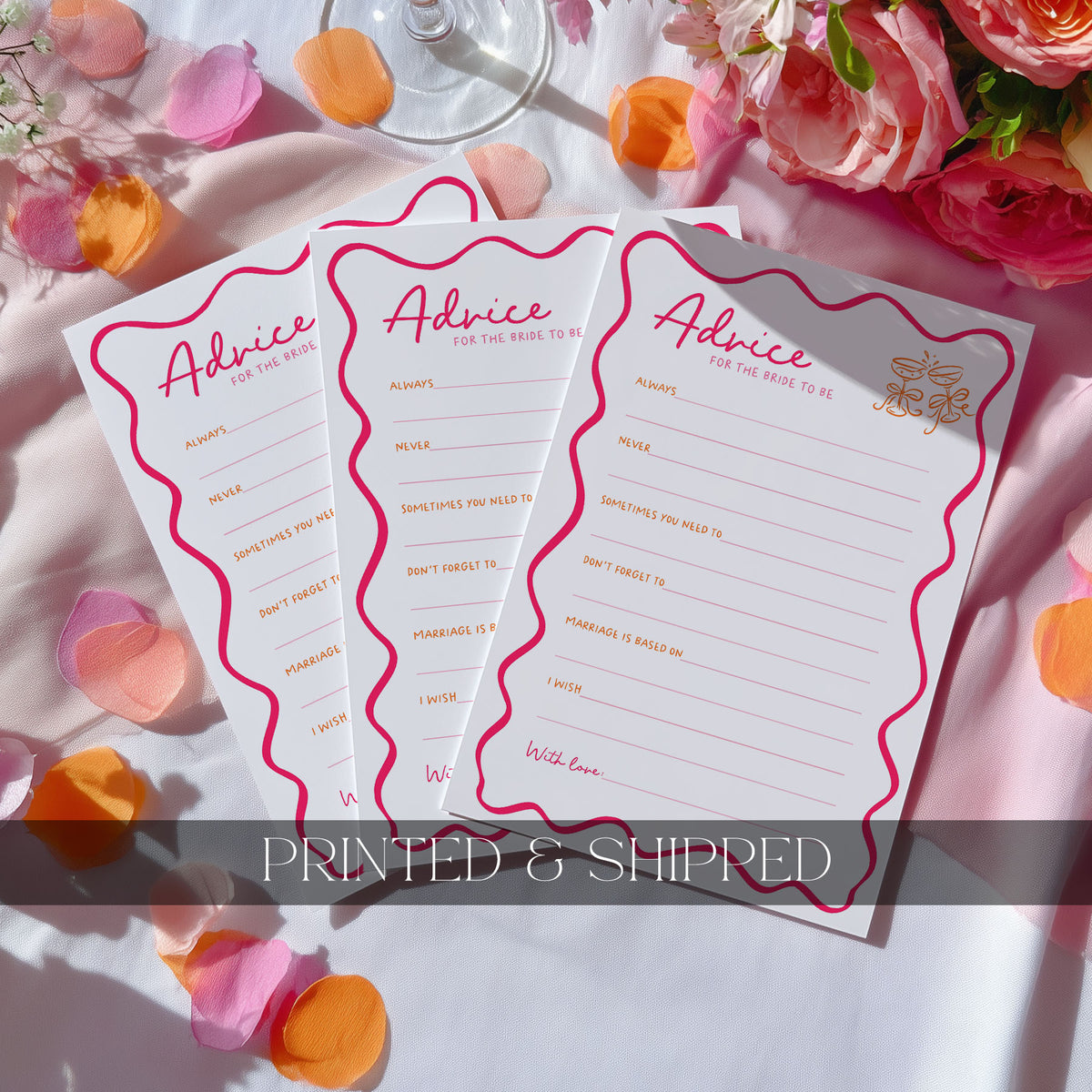 Three white 'Advice for the Bride' cards with pink wavy borders and gold foil text, arranged on a white fabric surface with pink rose petals and flowers. A translucent banner at the bottom reads 'PRINTED & SHIPPED'.