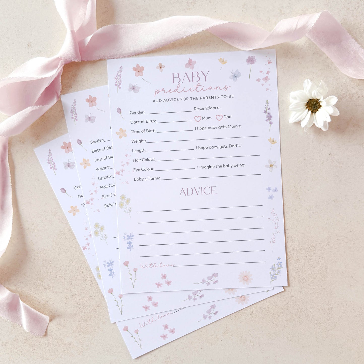 Baby prediction and advice cards with floral design on a light background with pink ribbon and white flower.