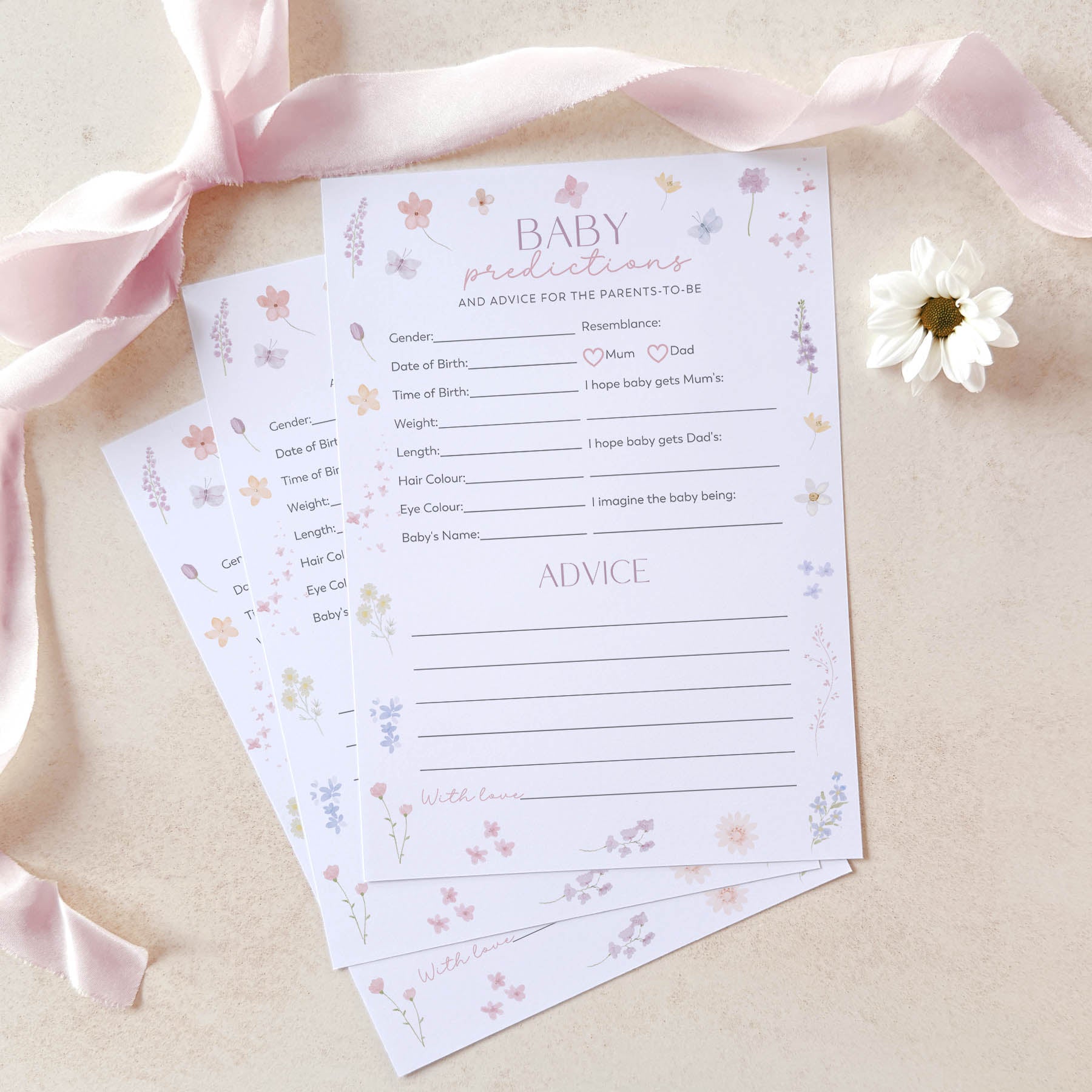 Baby prediction and advice cards with floral design on a light background with pink ribbon and white flower.