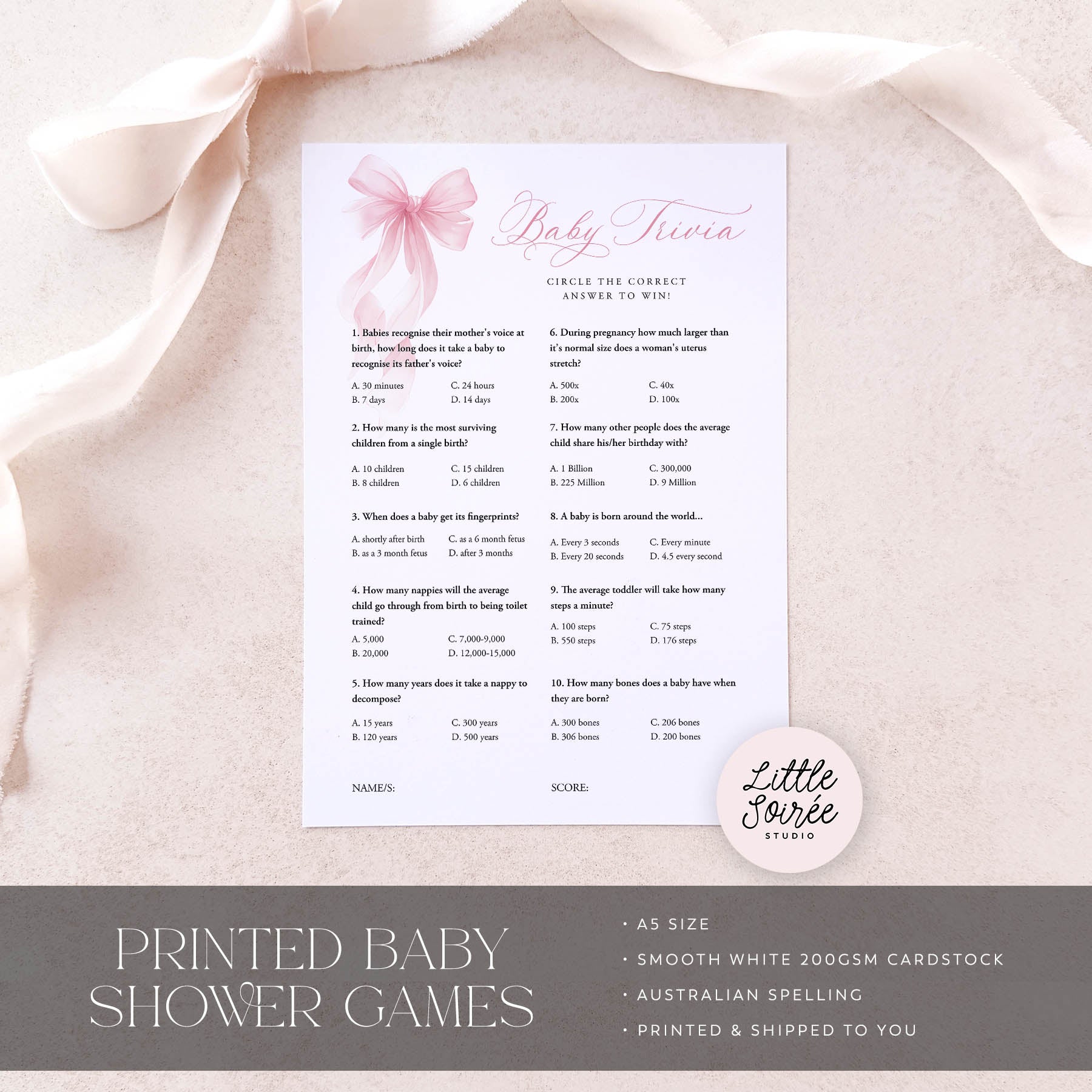 Baby trivia game card on a pink fabric background with 'Little Souris Studio' branding.